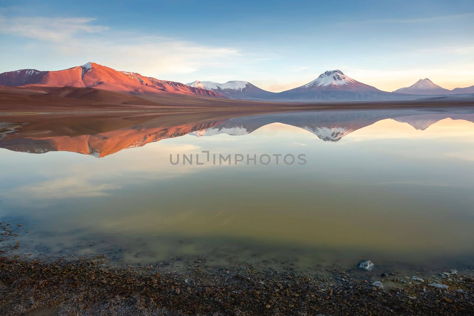 Salt lake Lejia reflection and idyllic volcanic landscape at Sunset, Atacama desert, Chile