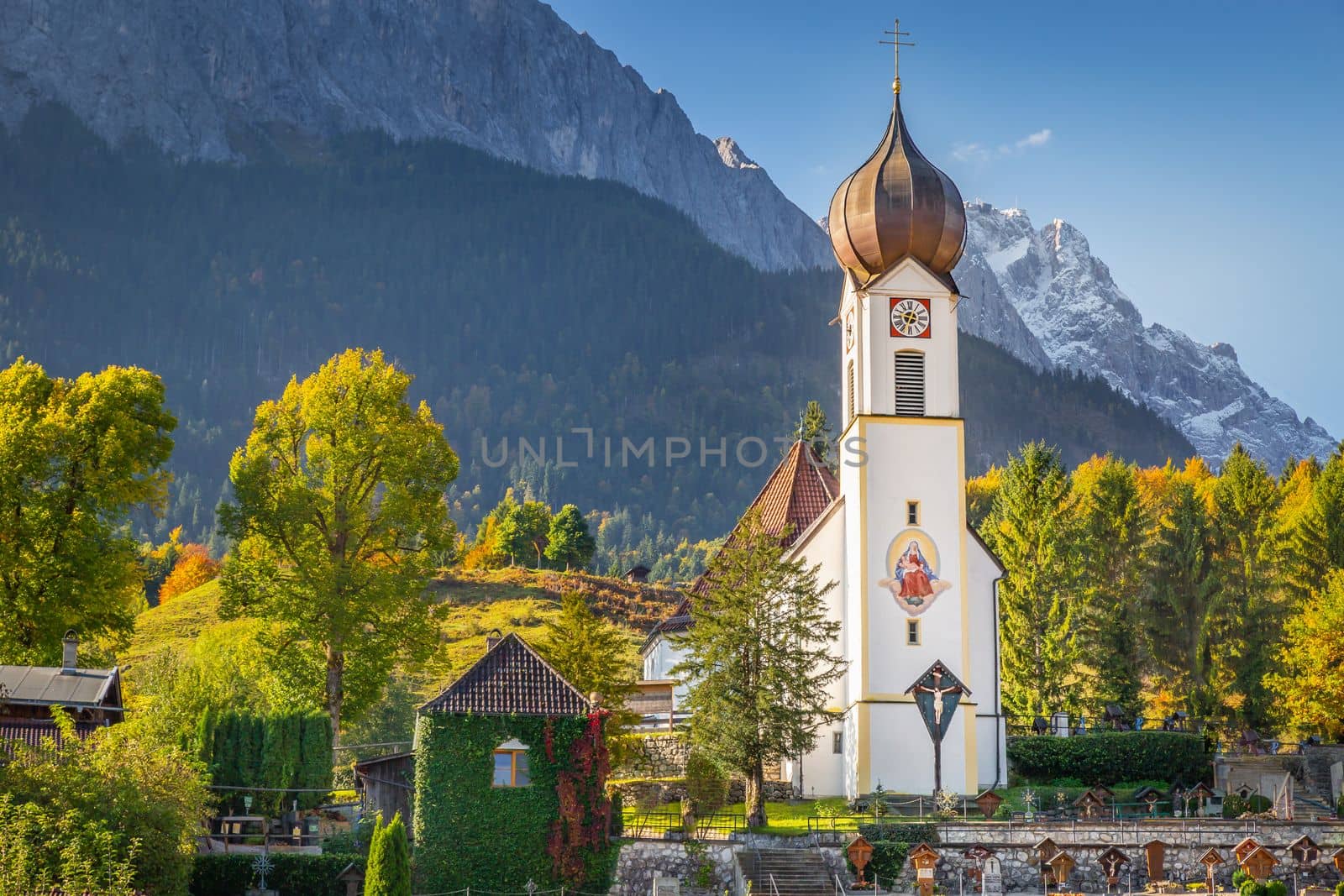 Grainau Church at golden autumn sunrise and Zugspitze massif, Bavarian alps , Germany