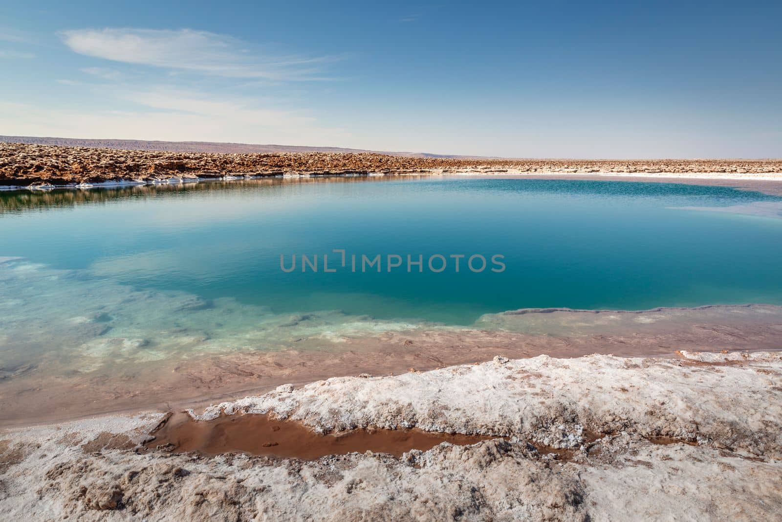 Salt lake reflection and idyllic volcanic landscape at sunrise, Atacama desert, Chile border with Bolivia