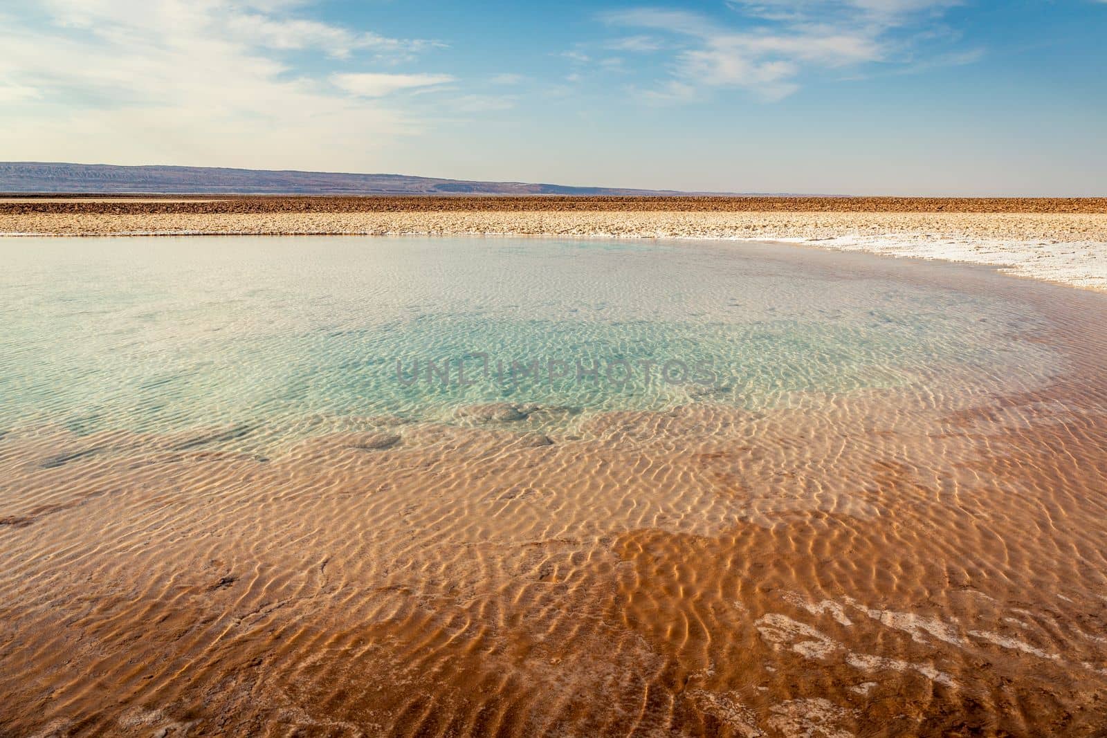 Salt lake reflection and idyllic volcanic landscape at sunrise, Atacama desert, Chile border with Bolivia