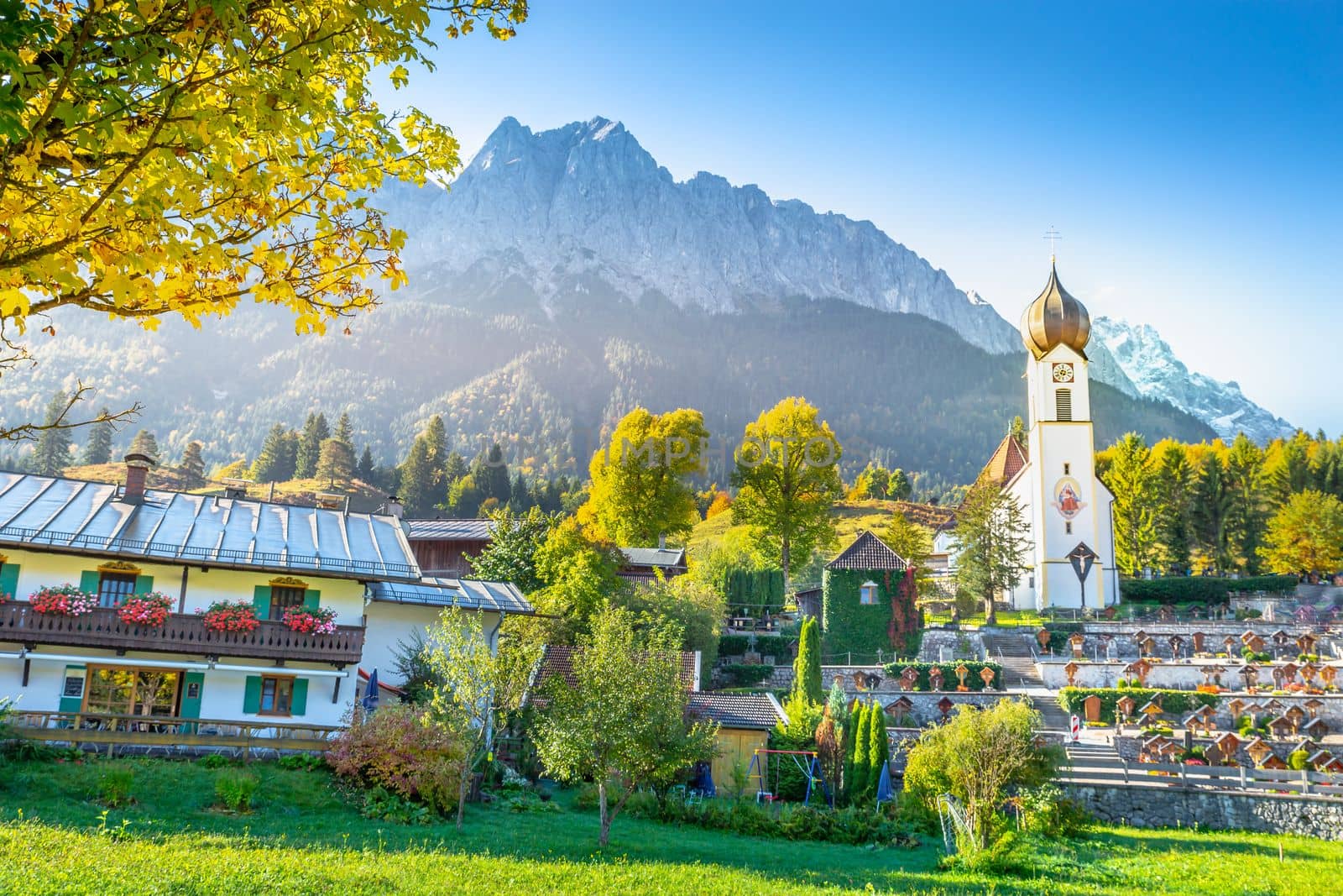 Grainau Church at golden autumn sunrise and Zugspitze massif, Bavarian alps , Germany