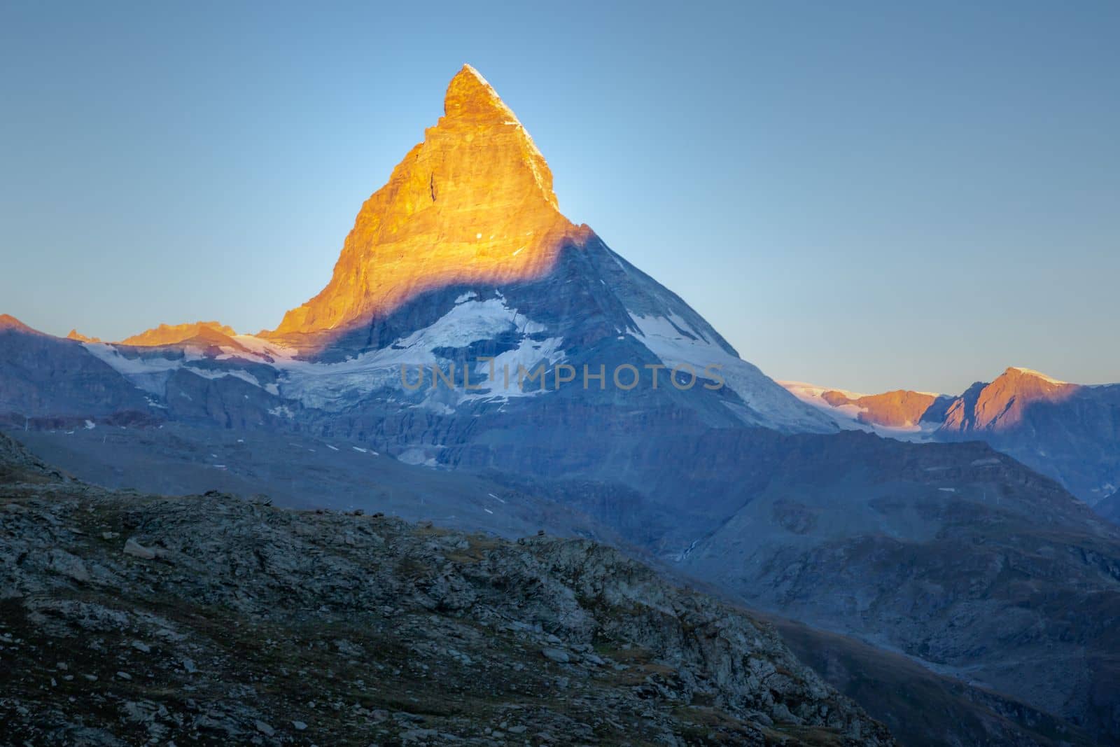 Reflection of the Matterhorn on blue and placid lake at sunrise, Swiss Alps, Zermatt, Switzerland