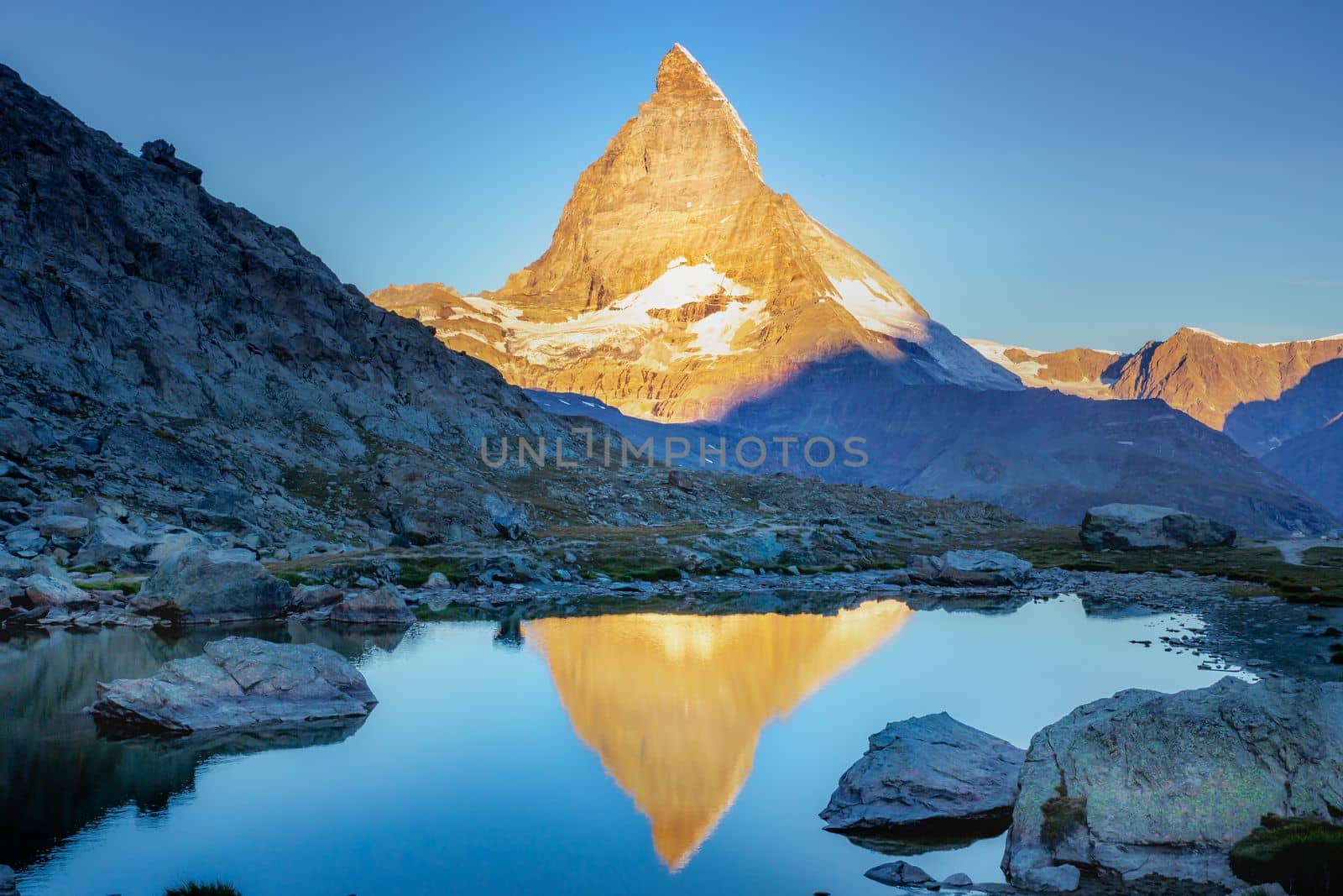 Reflection of the Matterhorn on blue lake at sunrise, Swiss Alps, Zermatt by positivetravelart