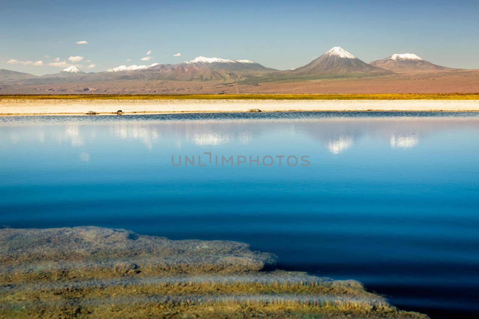 Licancabur and Peaceful reflection lake with dramatic volcanic landscape at Sunset, Atacama Desert, Chile