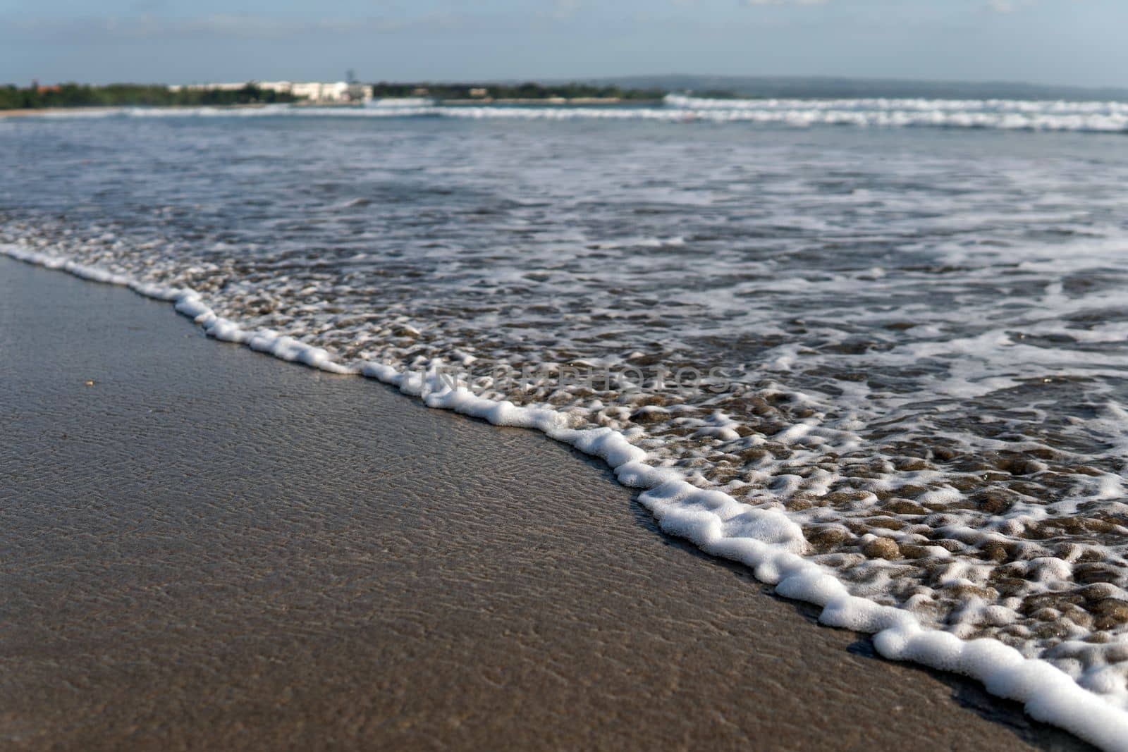 white foam on the shore by Alexzhilkin