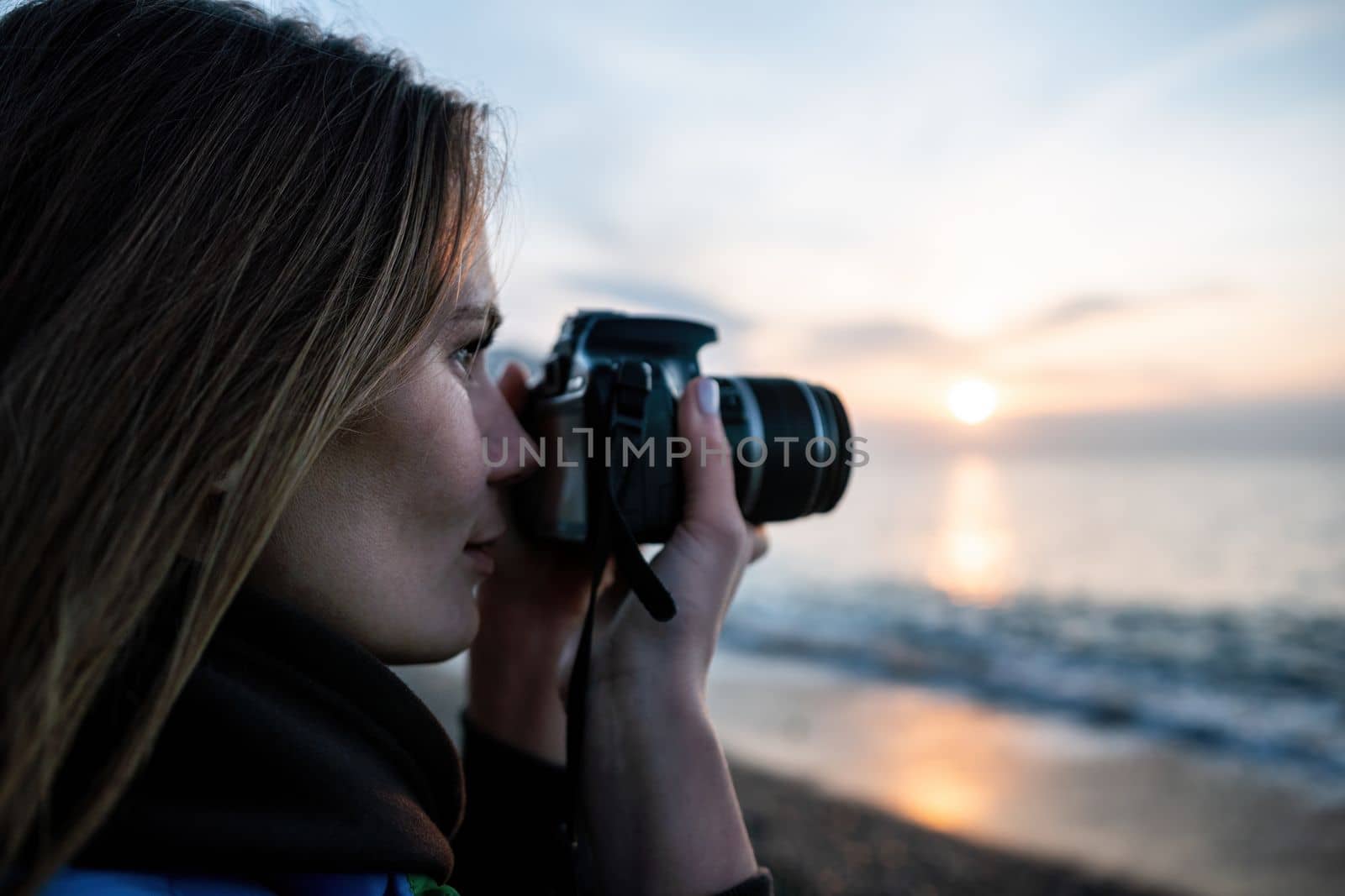 Woman travel sea. Happy tourist enjoy taking picture outdoors for memories. Woman traveler looks at sea bay of mountains, sharing travel adventure journey by panophotograph
