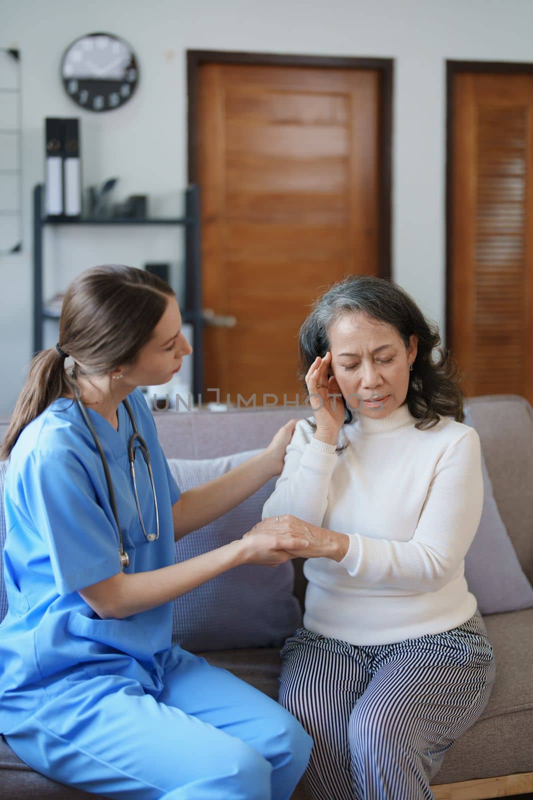 Portrait of a female doctor holding a patient's hand to encourage the fight against disease