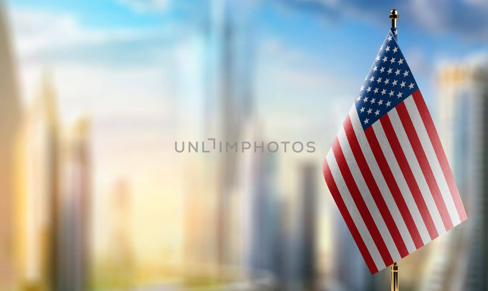 Small flags of the USA on an abstract blurry background.