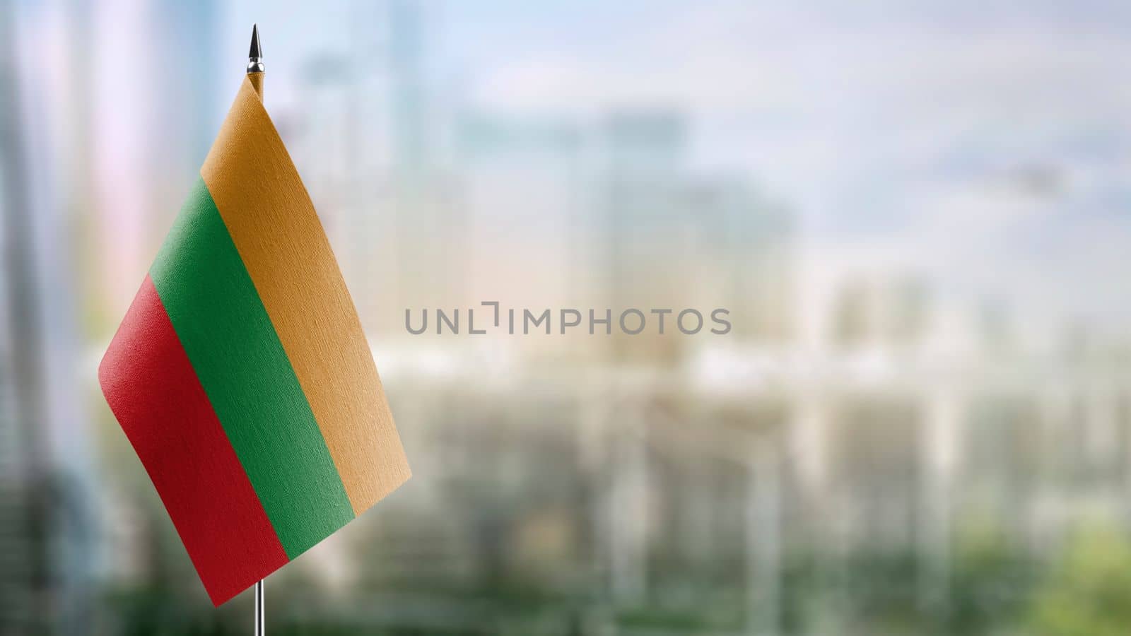 A small Lithuania flag on an abstract blurry background.
