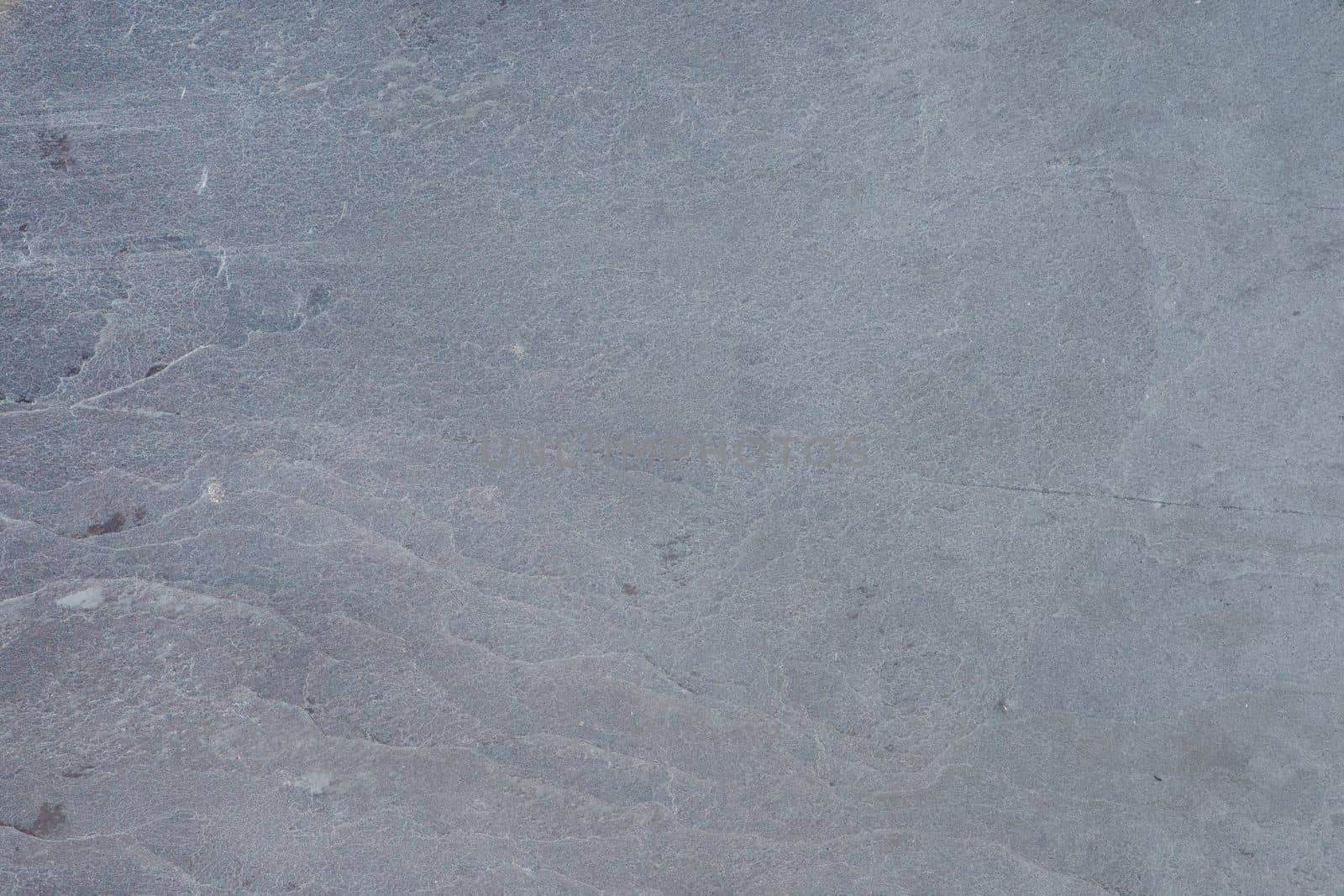 Texture of natural stone. Natural stone surface for flooring or wall decoration. Samples of gray stone with a wavy pattern for the interior.