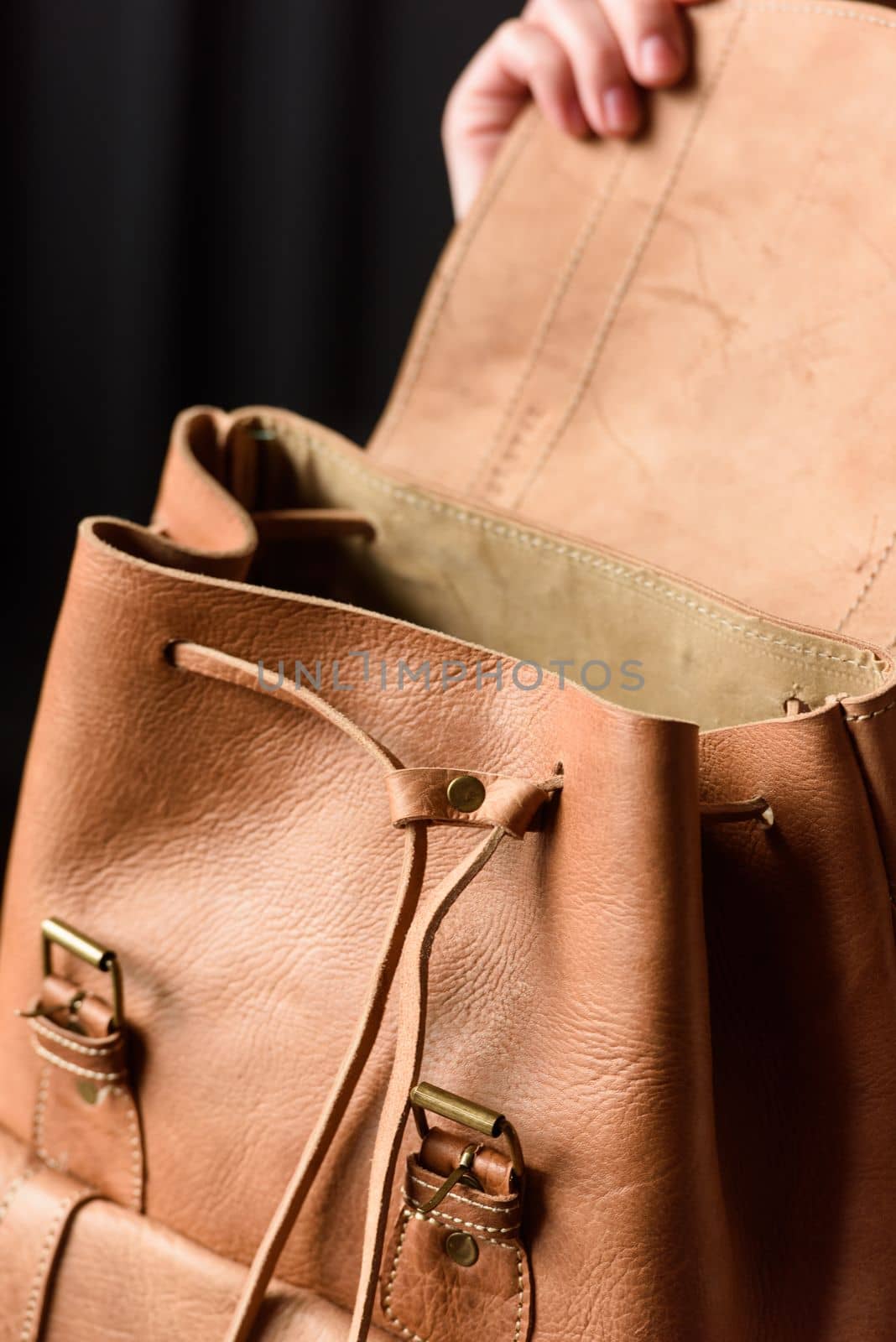 photo of a light brown leather backpack with antique and retro look. indoors photo by Ashtray25