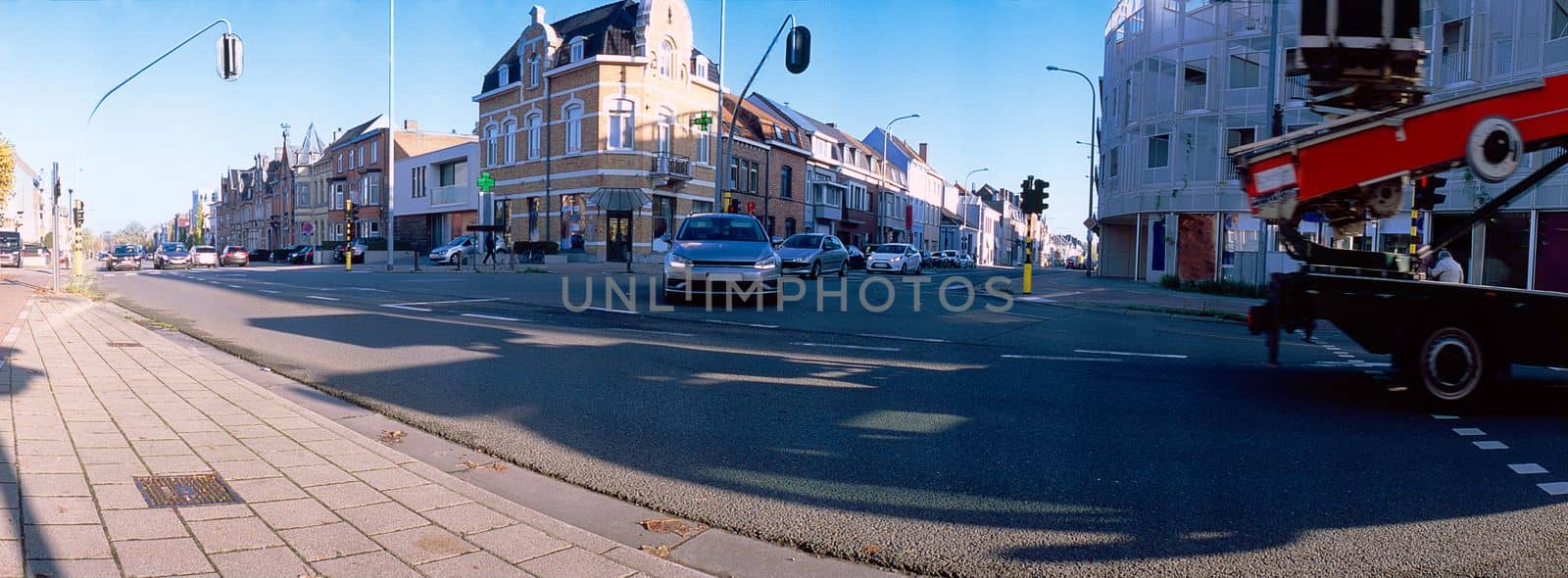 panoramic lowangle view on traffic passing a signalized junction on a sunny day
