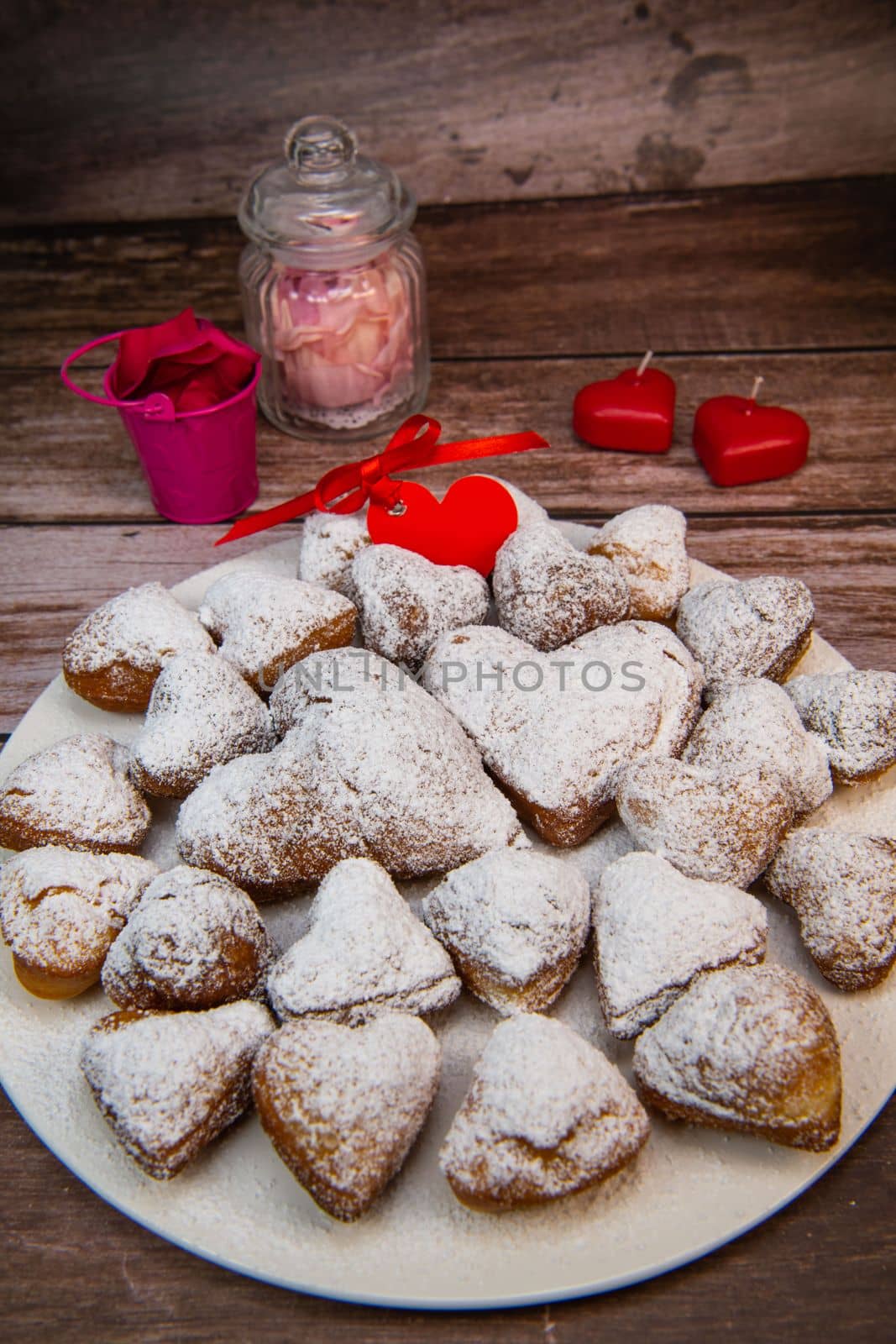 Recipe for soft heart-shaped doughnuts for Valentine's Day. High quality photo