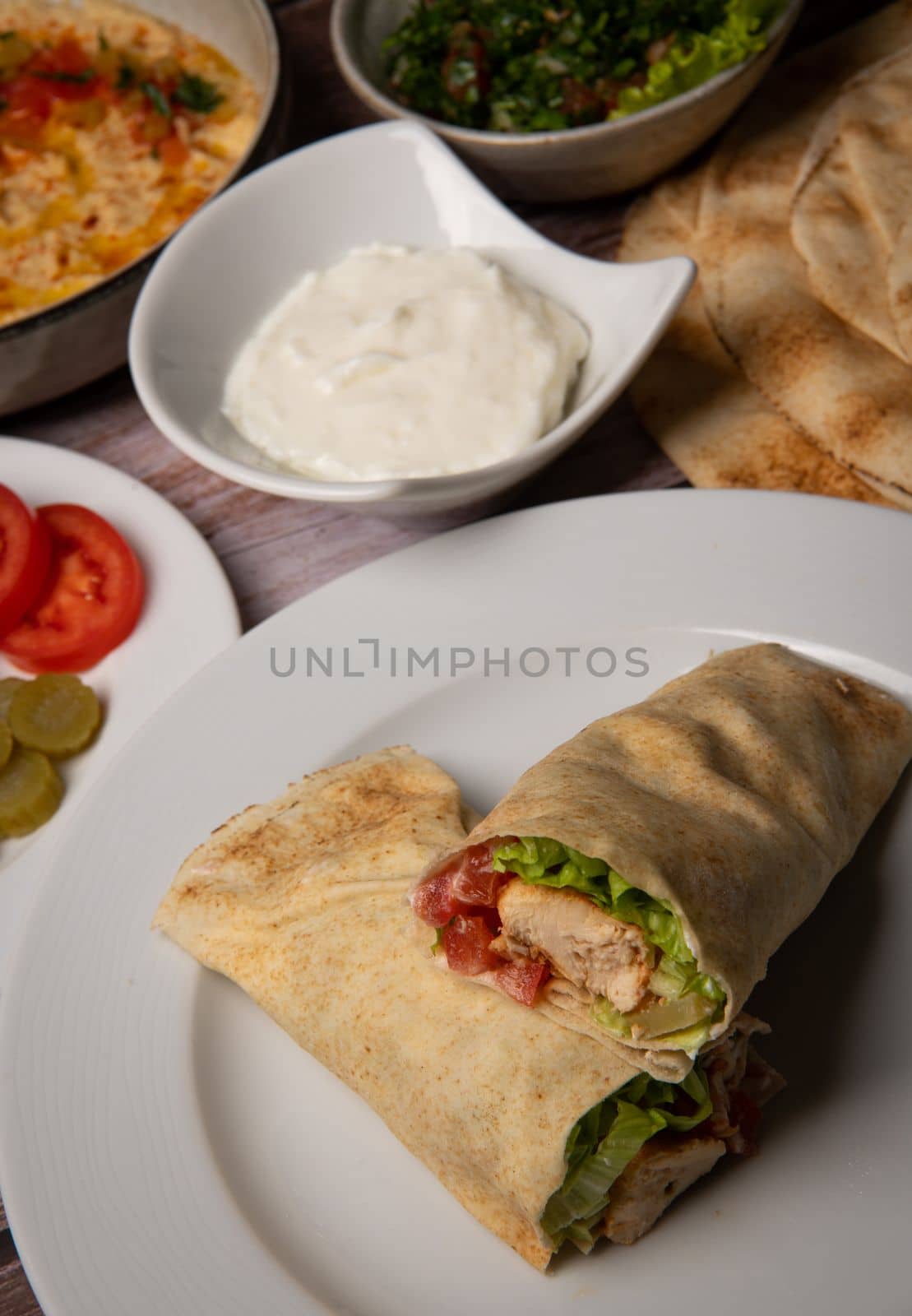 Lebanese recipe of chich taouk, garlic cream, toum, in a Lebanese bread, tabbouleh and chickpea puree, hummus High quality photo