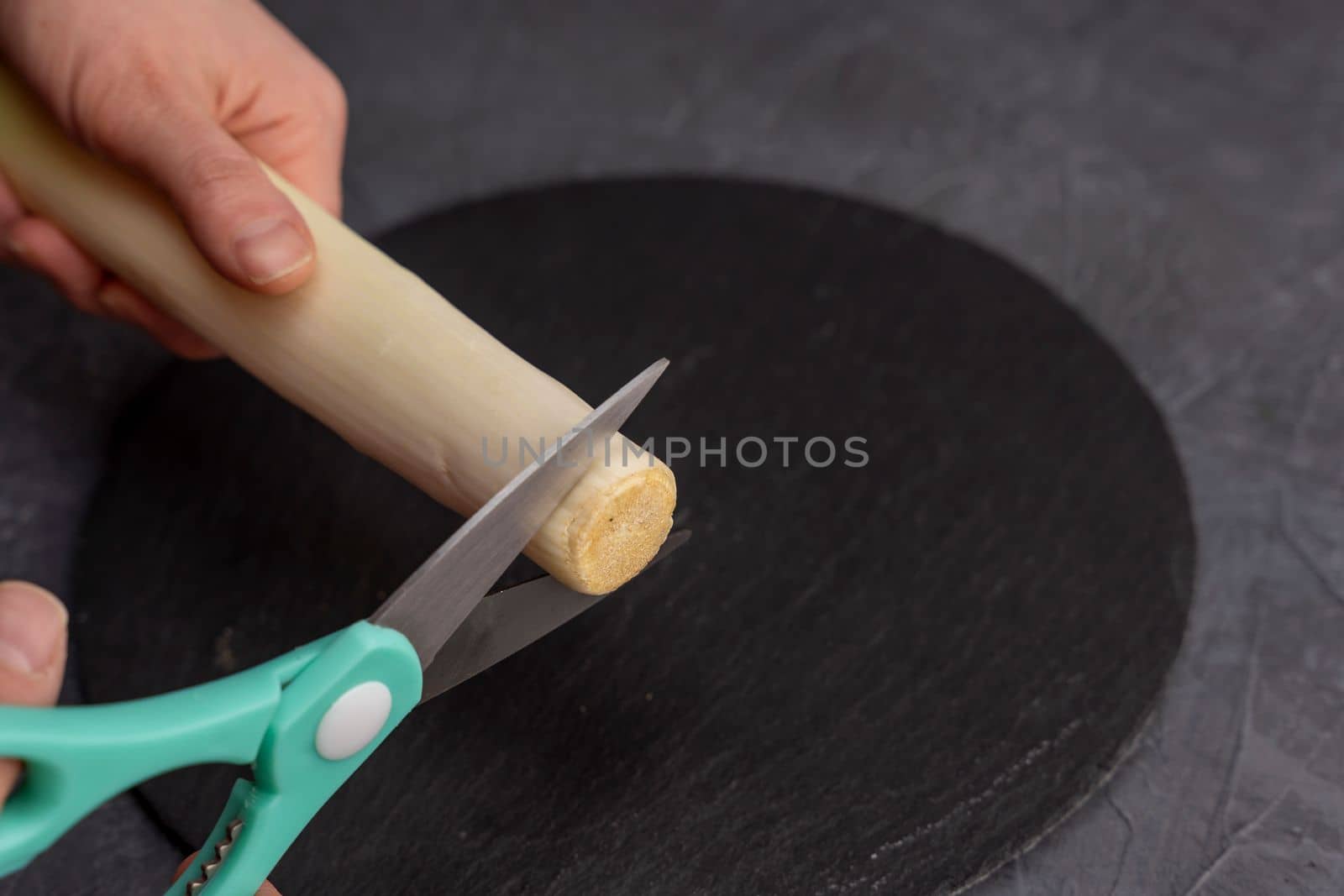 kitchen scissors cut leeks on a slate cutting board in the kitchen by audiznam2609