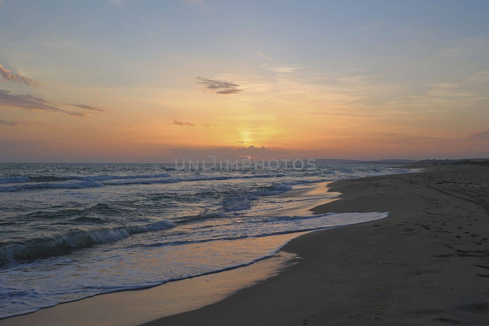 Sea with sunset sky and sun through the clouds. Ocean and sky for meditation. Calm seascape. Horizon over water