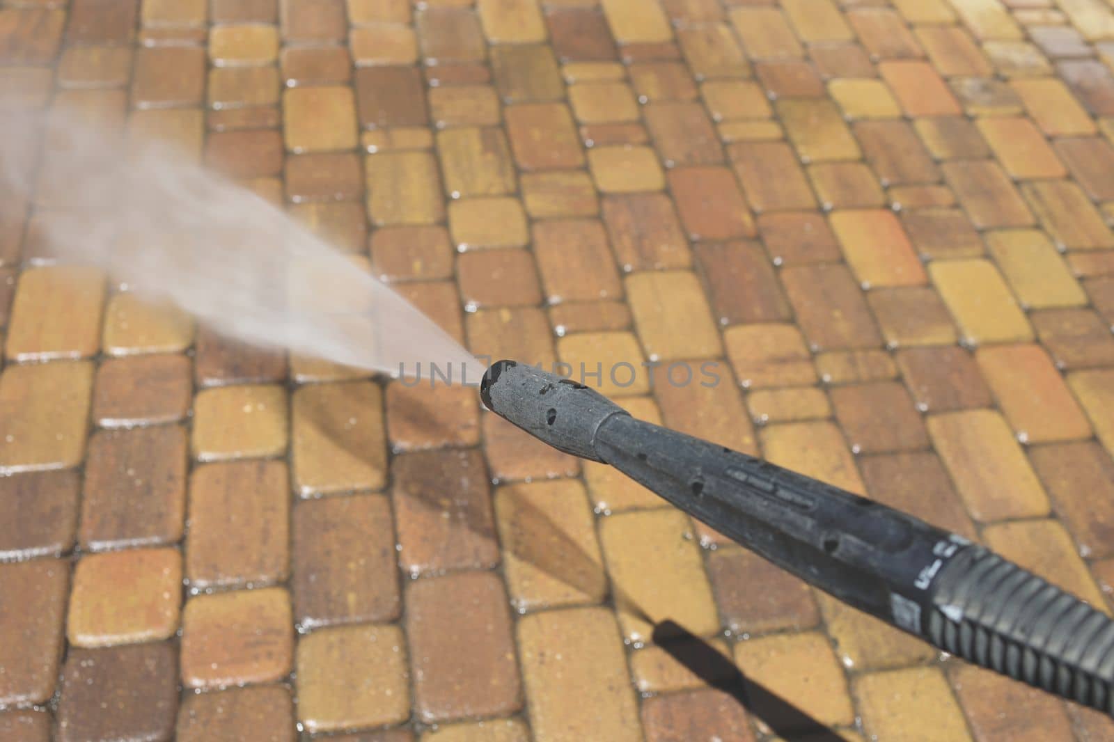 Cleaning backyard paving tiles with high pressure washer. Spring clean up. Cleaning dirty backyard paving tiles with pressure washer cleaner by Proxima13