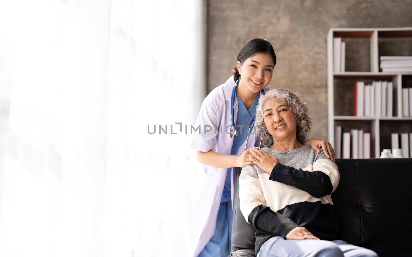 Home caregiver and senior woman holding hands. Professional Elderly Care. Professional care for elderly at nursing homes. Nurse holding hand of senior woman in rest home by nateemee