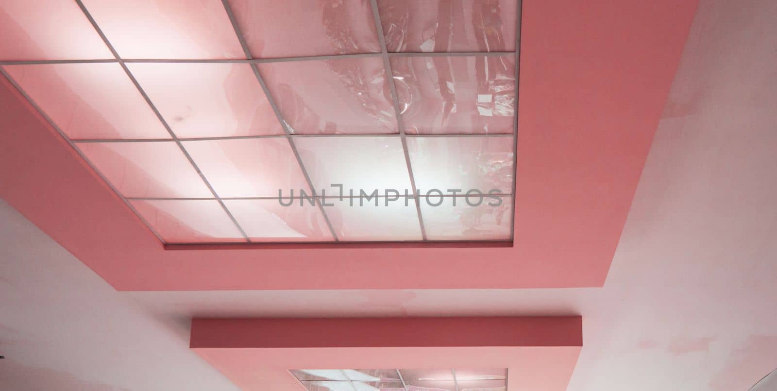 Pink ceiling with reflective tiles in a modern office space, conference room design by claire_lucia