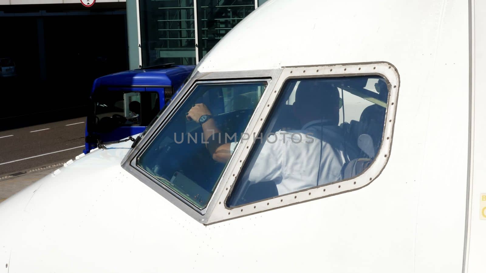 Ukraine International Airlines. the pilot in the cockpit in the plane. preparing for the next flight, view from the outside. High quality photo