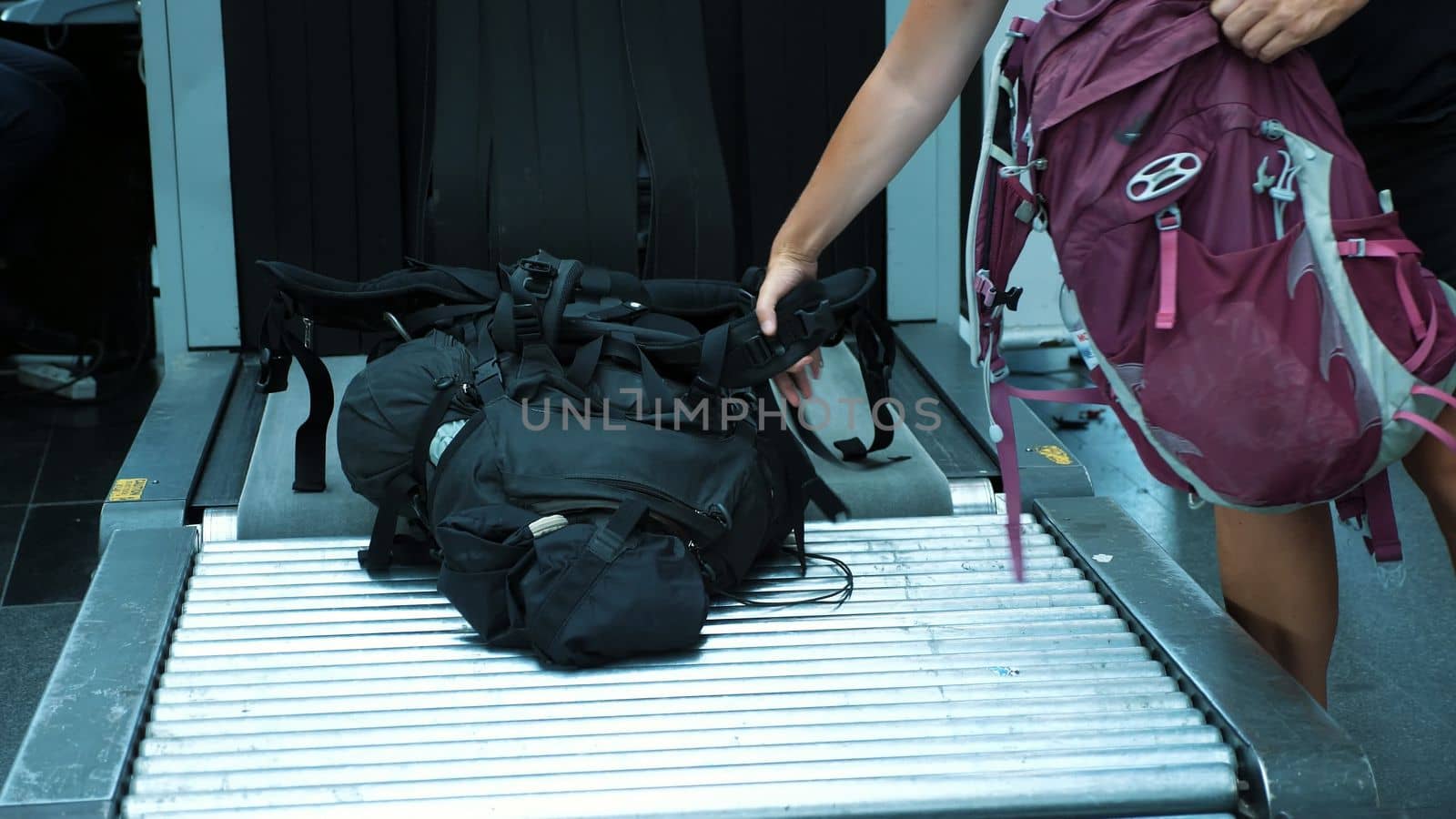 close-up. passengers take their bags, Baggage from conveyor belt, after they have passed x-ray luggage scanner, check at airport. High quality photo