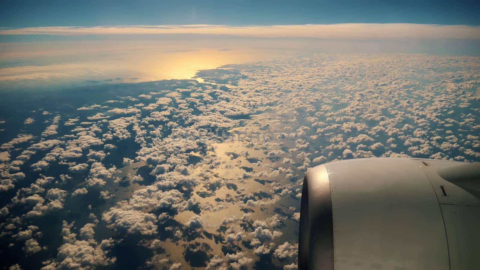 airplane window with blue sky and clouds outside. High quality photo