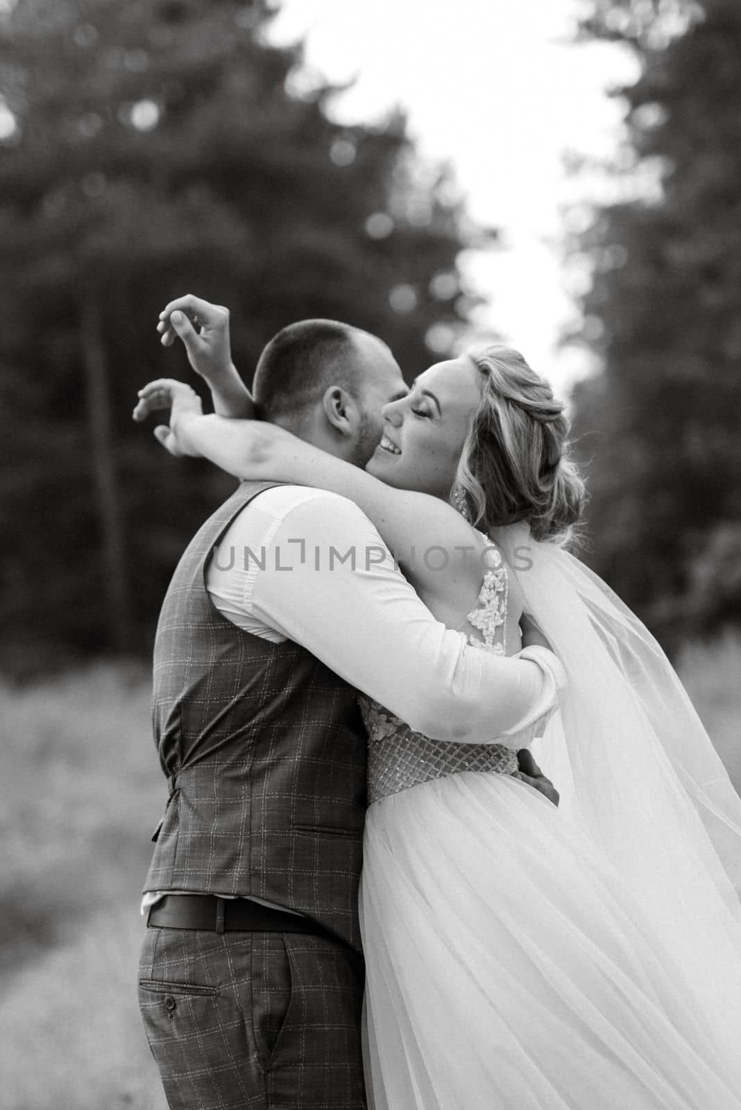 the groom and the bride are walking in the forest on a bright day