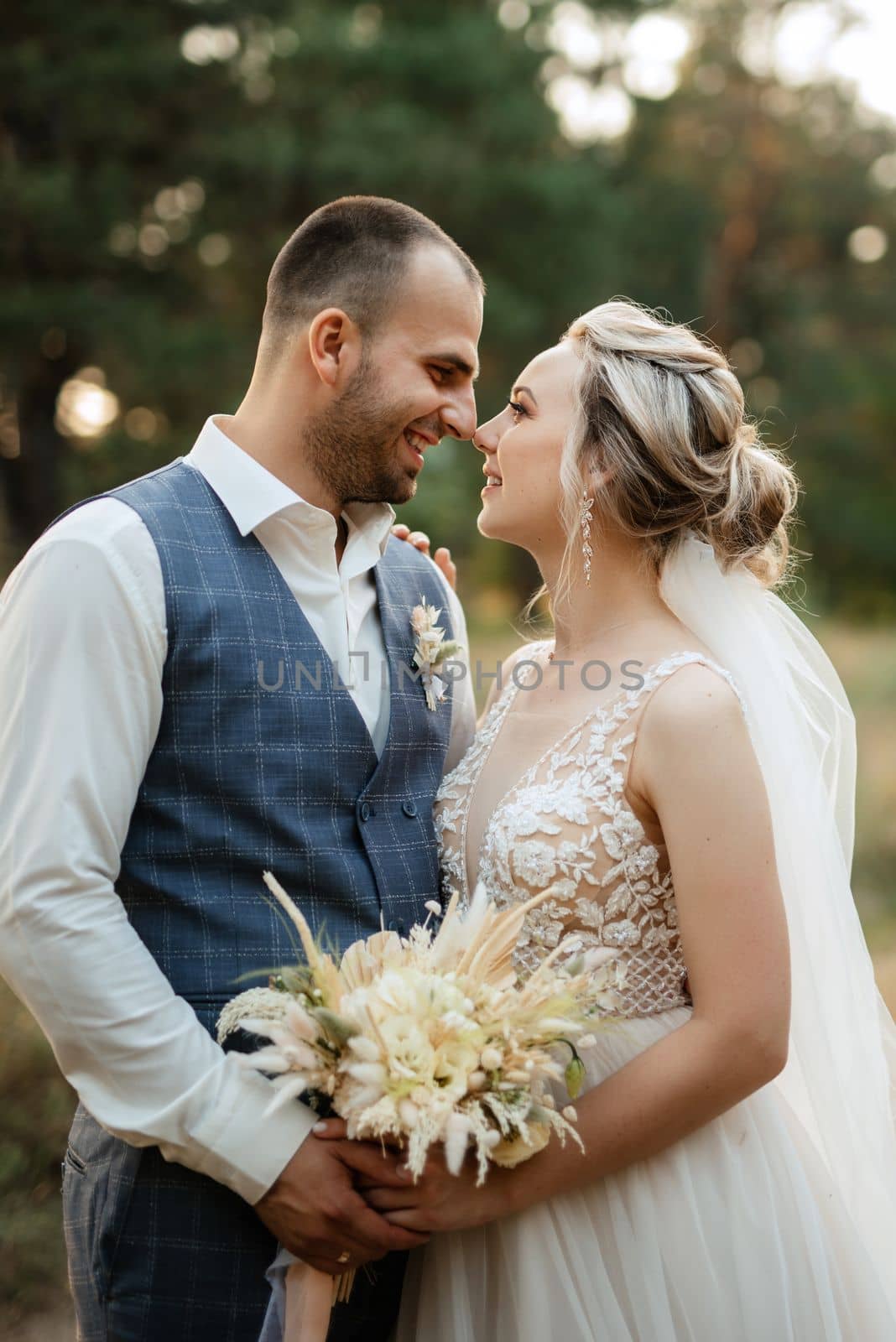 the groom and the bride are walking in the forest on a bright day