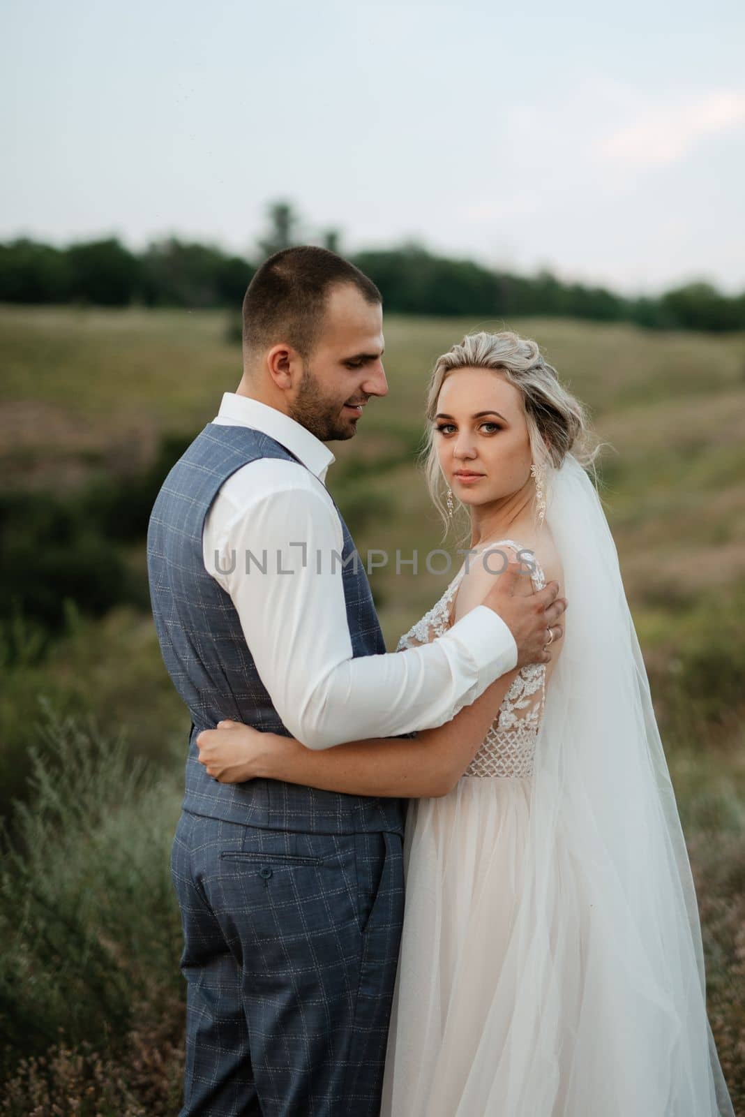 bride blonde girl and groom in a field by Andreua
