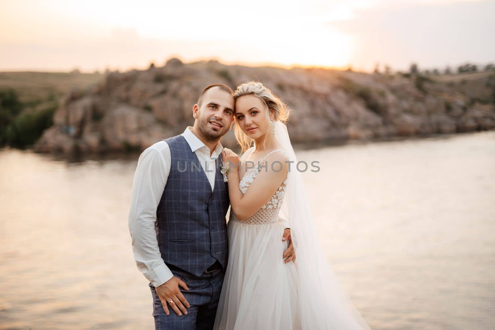 bride blonde girl and groom near the river by Andreua