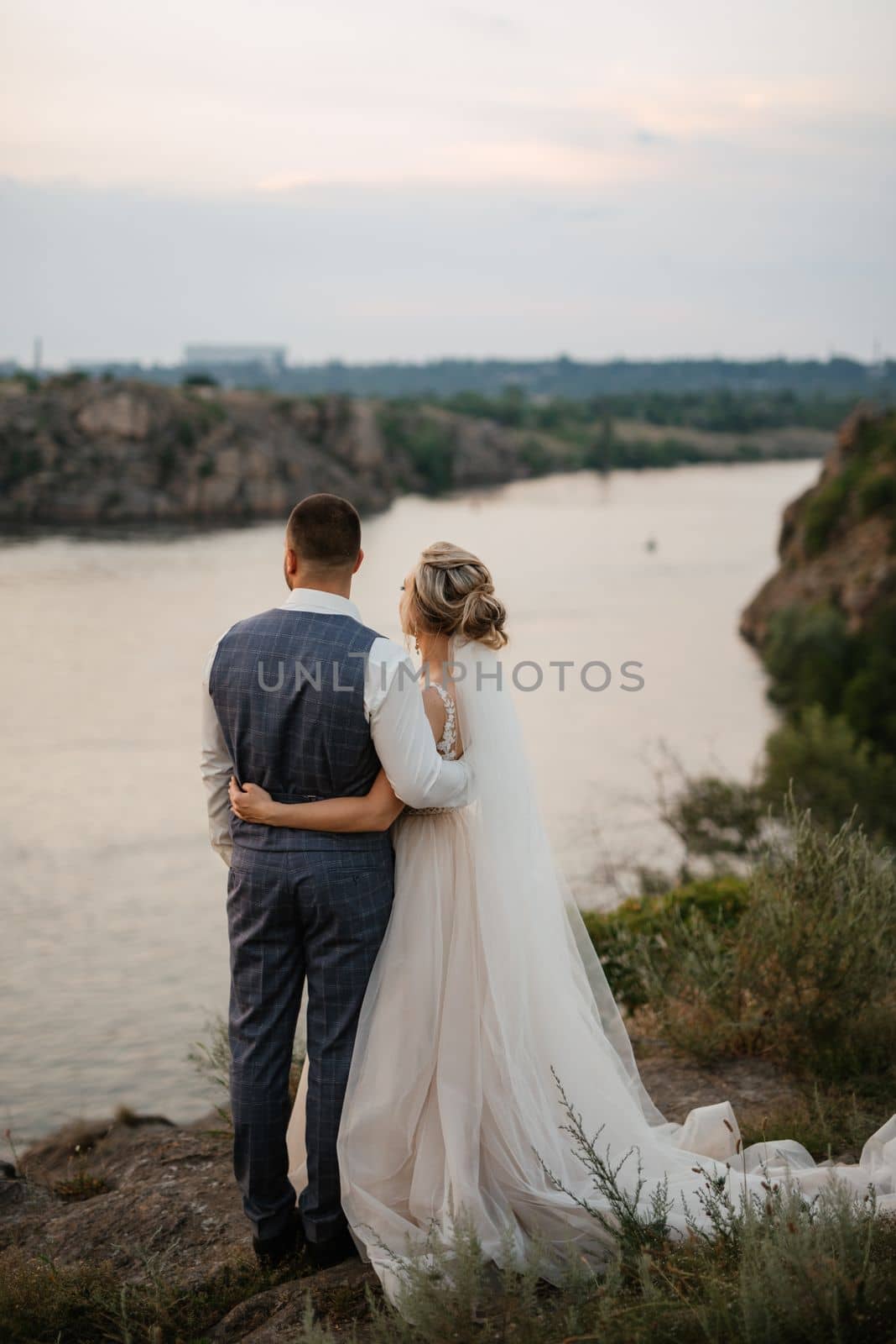 bride blonde girl and groom near the river by Andreua