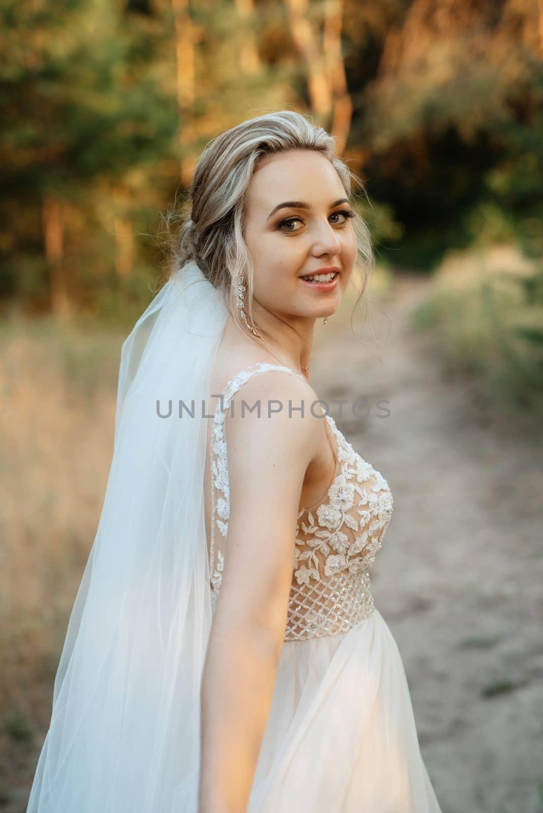 bride blonde girl with a bouquet in the forest by Andreua