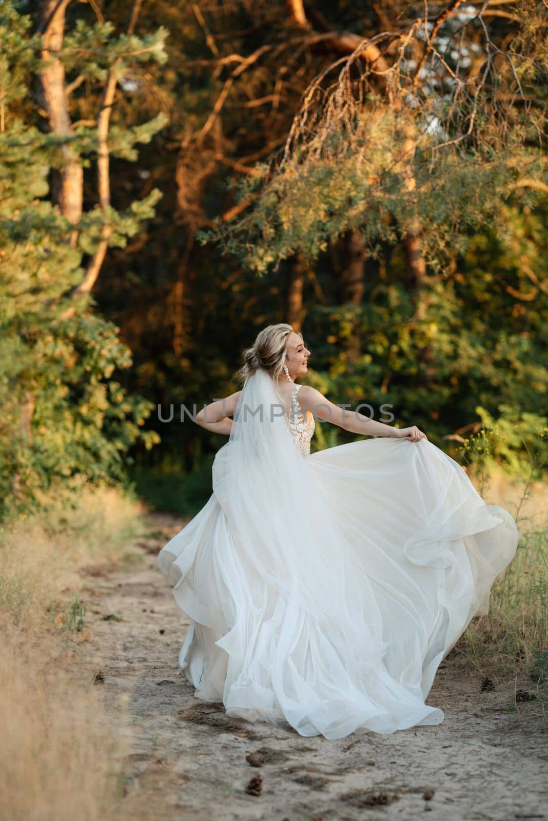 bride blonde girl with a bouquet in the forest by Andreua