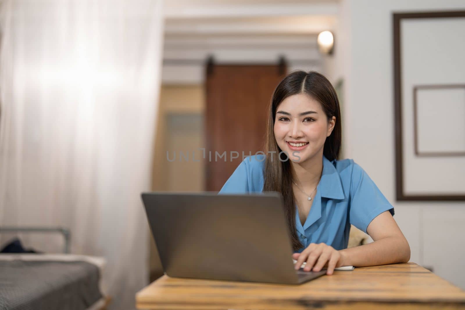 Beautiful business woman using a laptop computer. Portrait of asian...