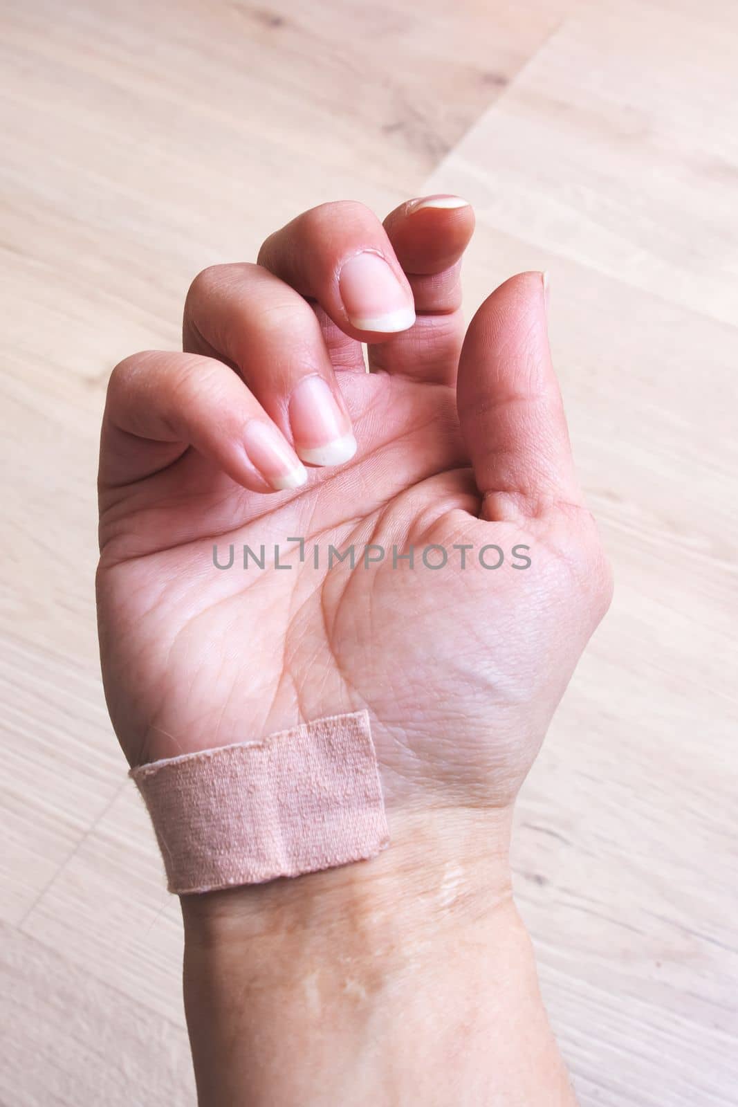 Woman's hand with adhesive plaster close up