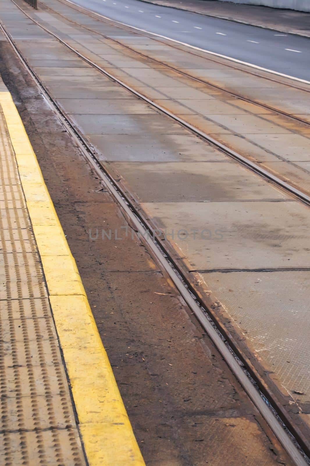 Rails for tram on asphalt in city close up