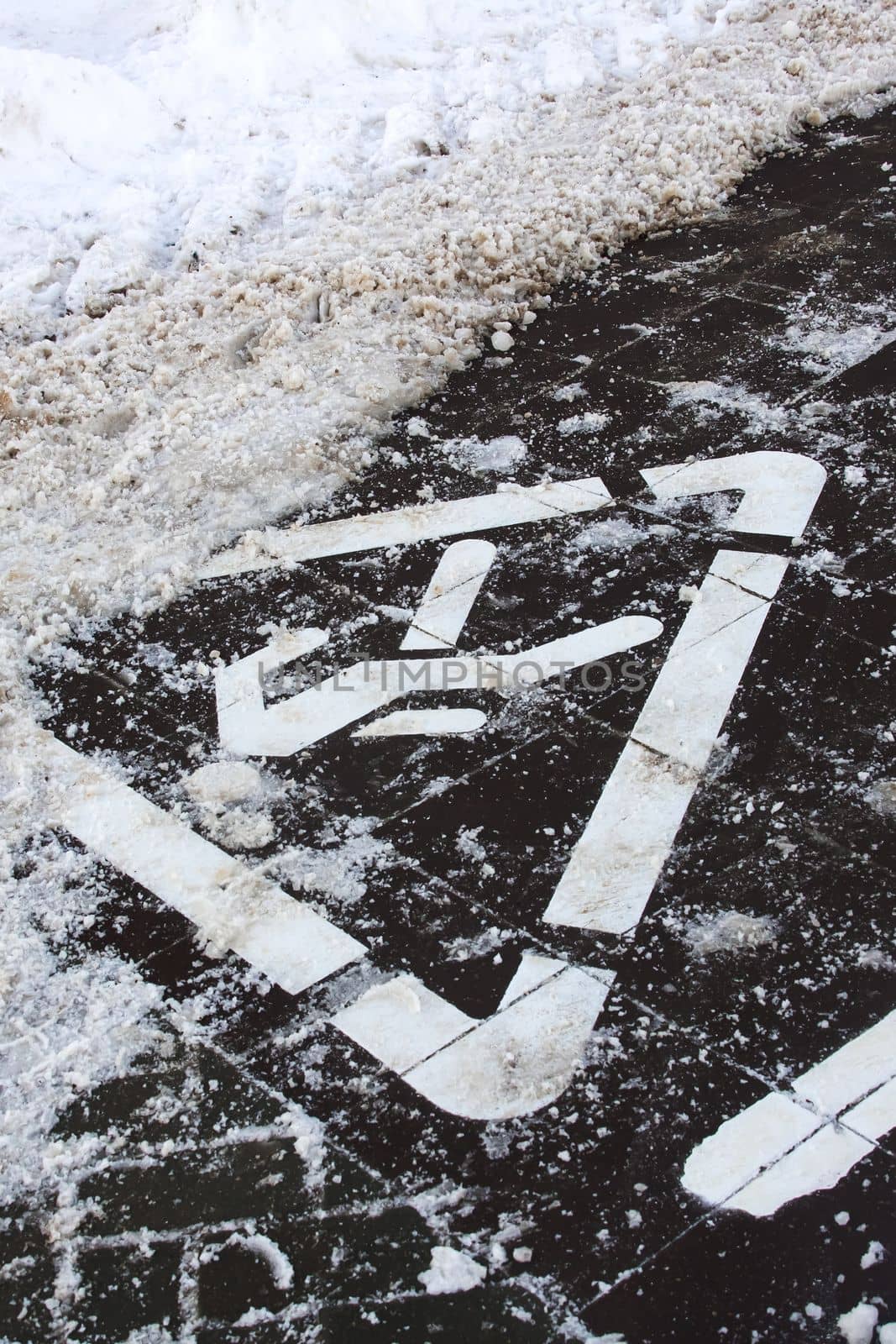 Sign footpath on the sidewalk in the snow close up