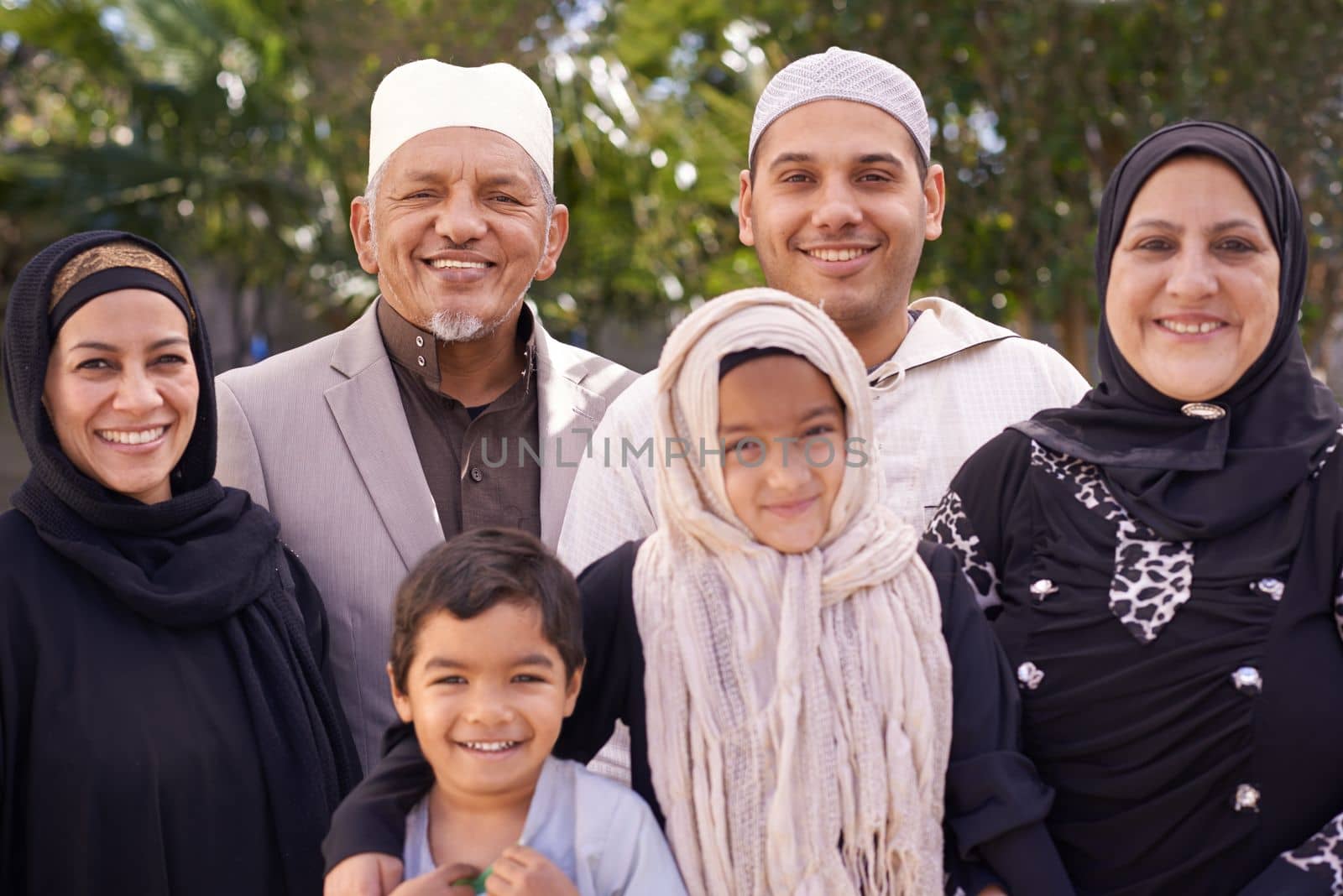 The perfect family photo. Portrait of a muslim family enjoying a day outside. by YuriArcurs