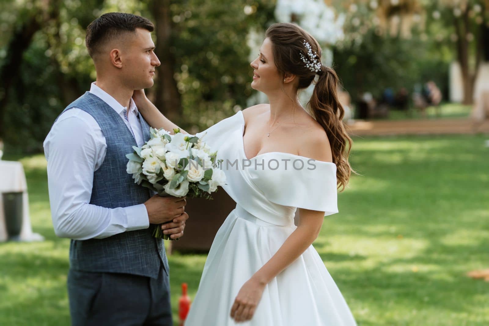 the first meeting of the bride and groom in wedding outfits in the park