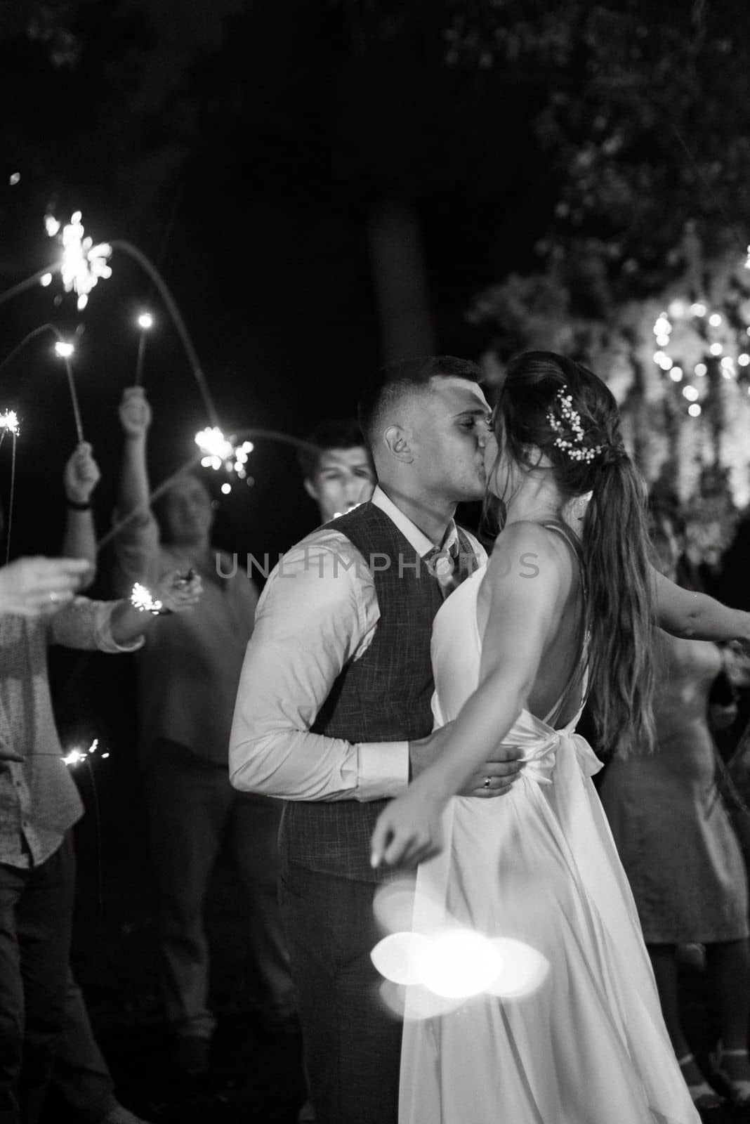 newlyweds at a wedding in the corridor of sparklers