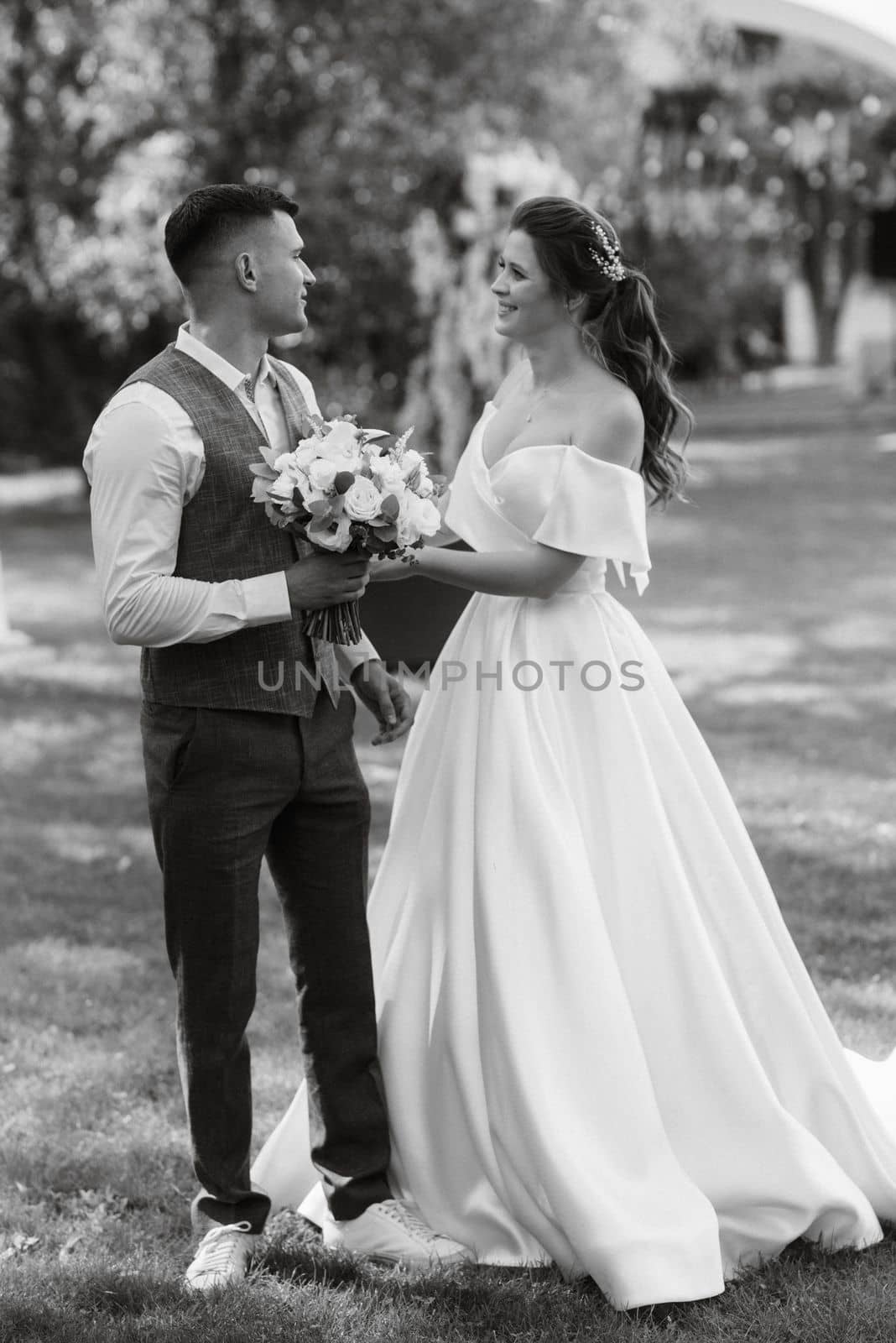 the first meeting of the bride and groom in wedding outfits in the park