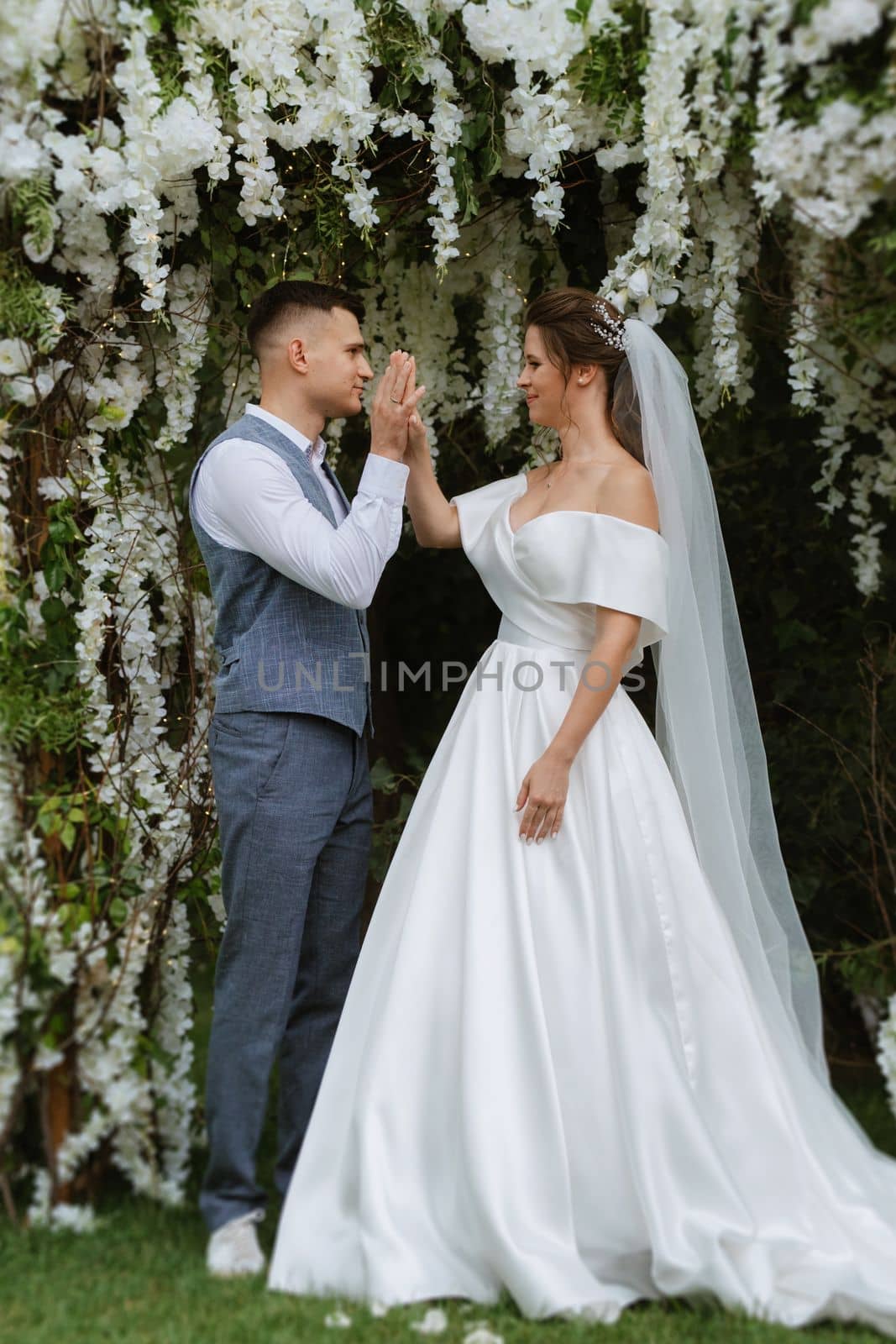 wedding ceremony of the newlyweds on the glade near the restaurant