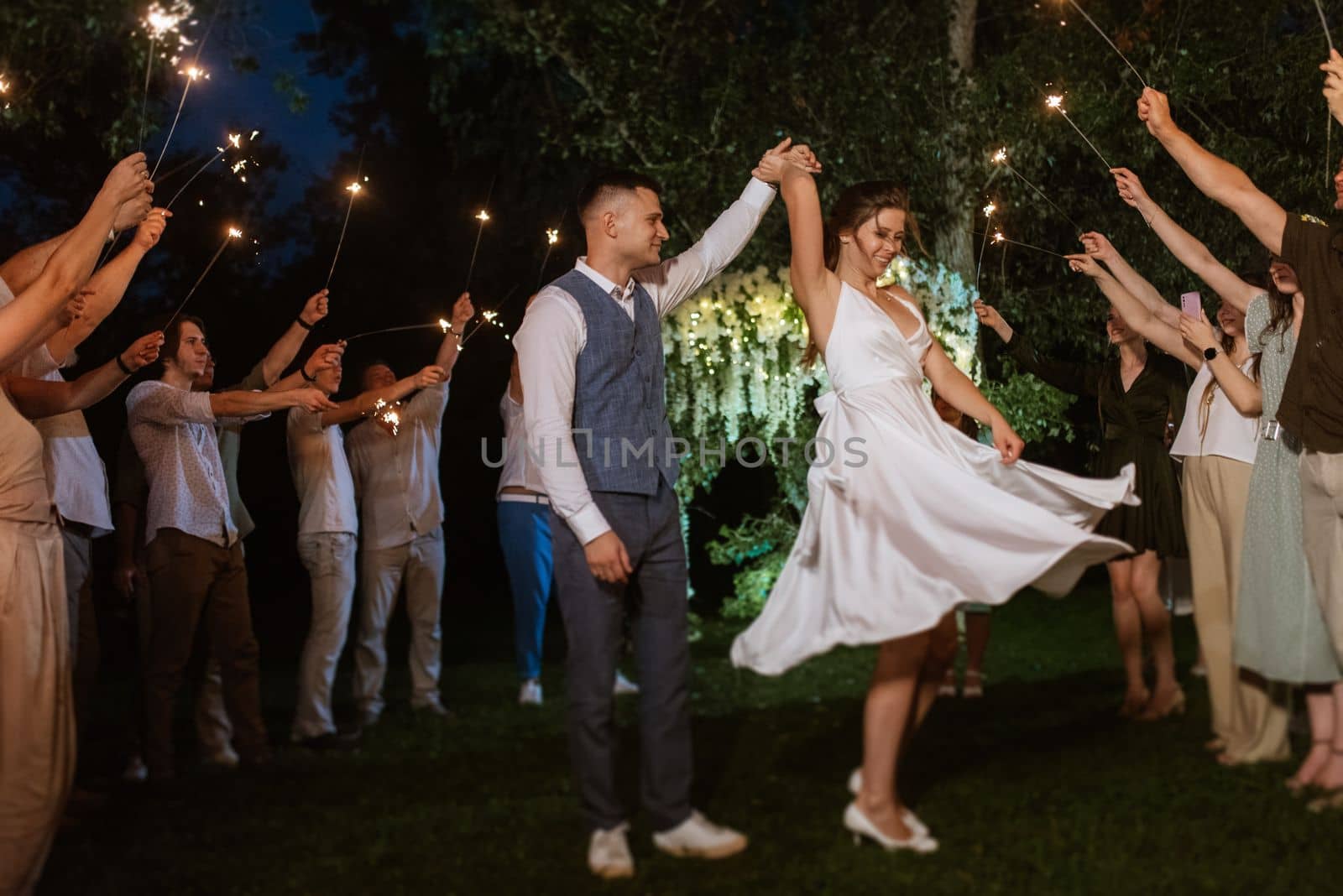 newlyweds at a wedding in the corridor of sparklers