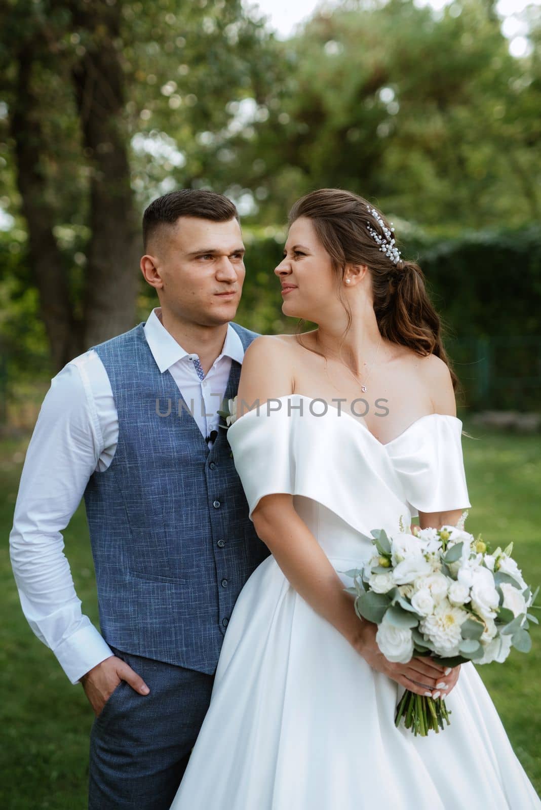 the first meeting of the bride and groom in wedding outfits in the park