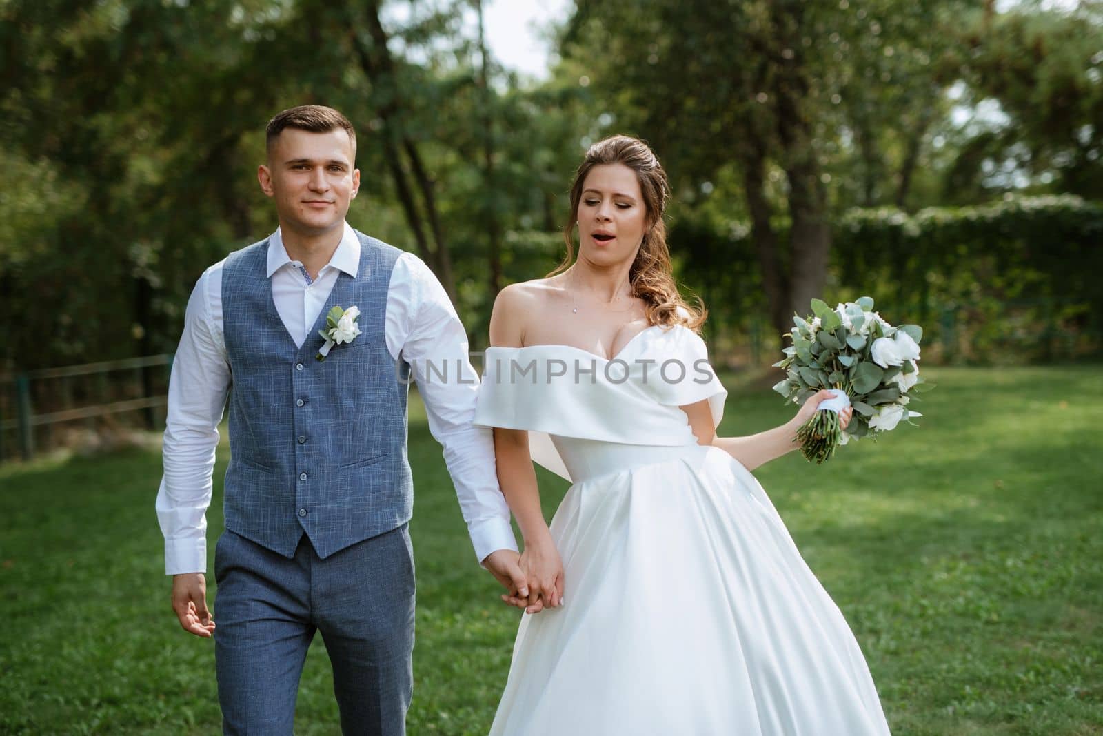 the first meeting of the bride and groom in wedding outfits in the park