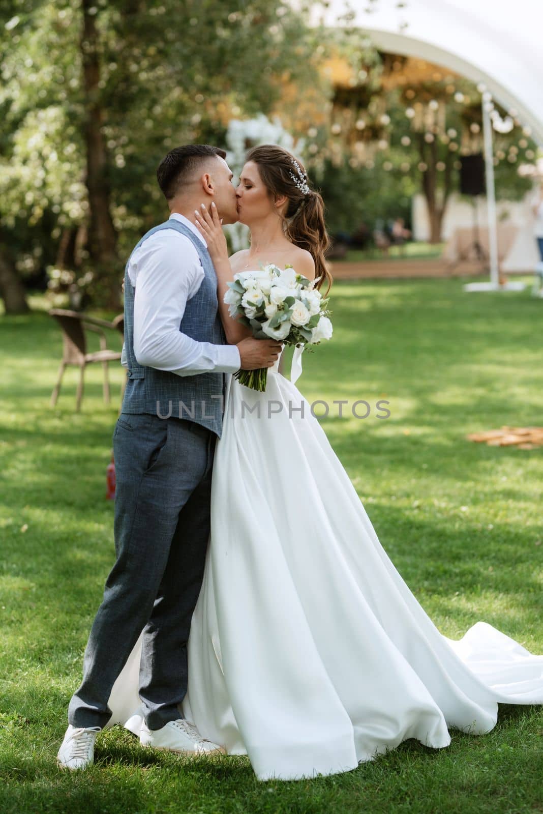 the first meeting of the bride and groom in wedding outfits in the park