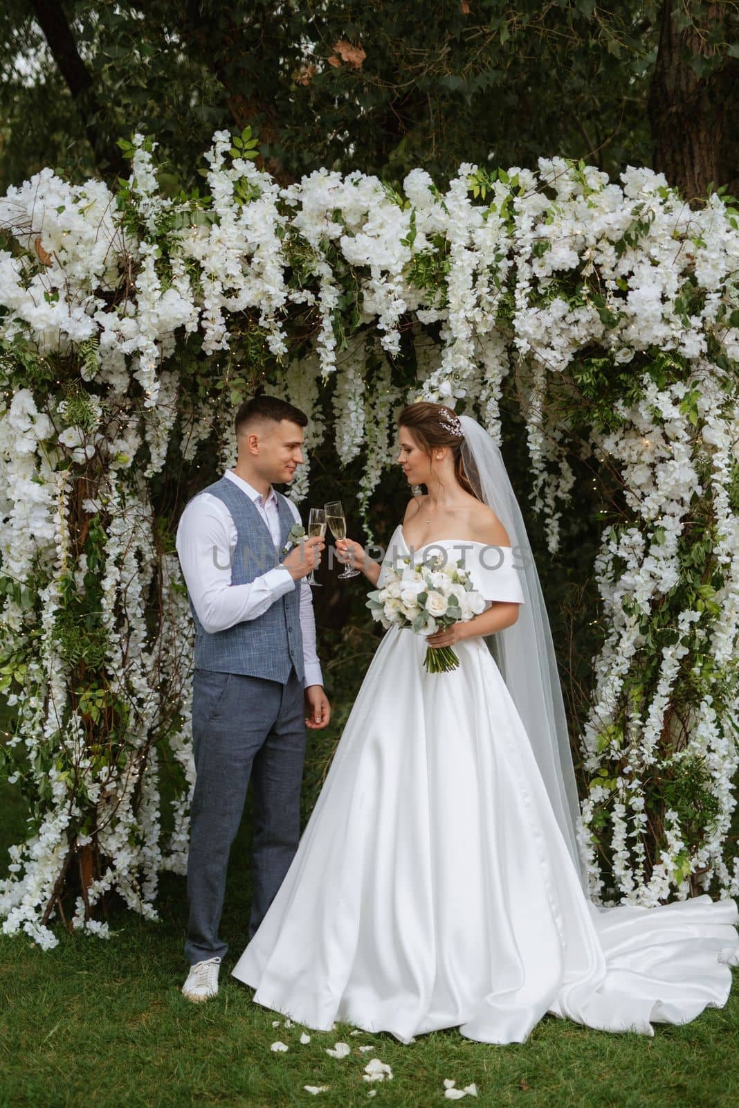 wedding ceremony of the newlyweds on the glade near the restaurant