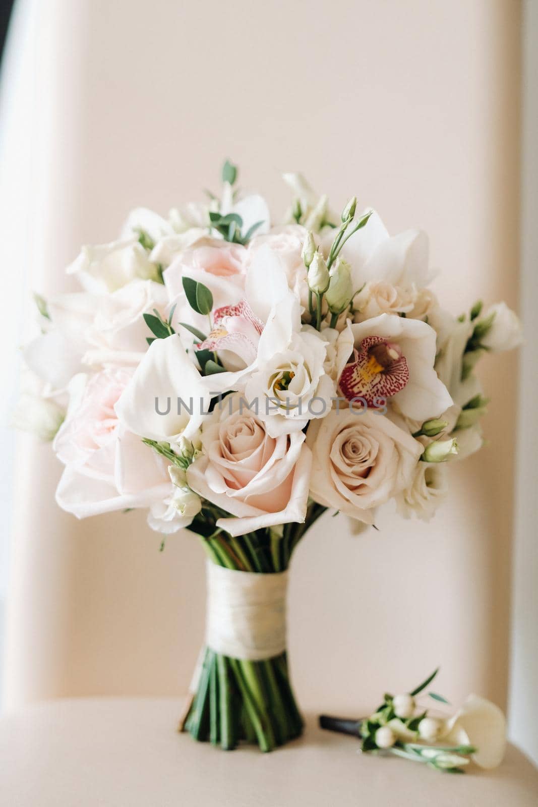 wedding bouquet with roses and boutonniere.The decor at the wedding.