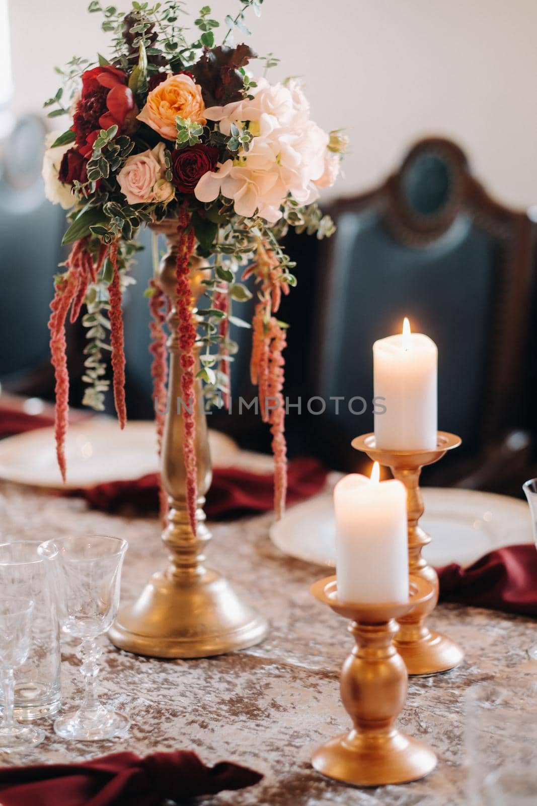 wedding table decoration with flowers on the table in the castle, table decor for dinner by candlelight.Dinner with candles by Lobachad