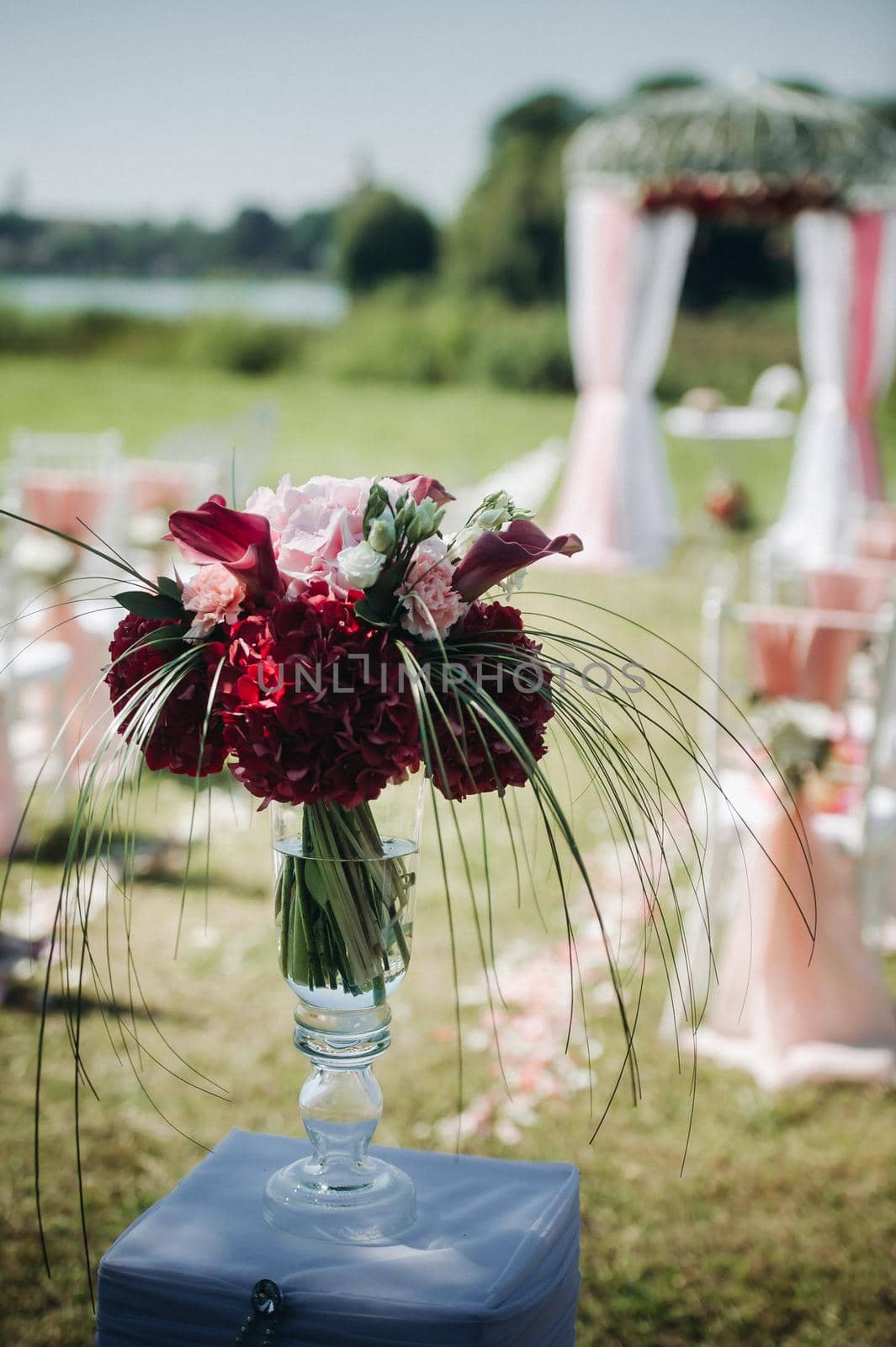 Wedding ceremony on the street on the green lawn.Decor with fresh flowers arches for the ceremony.